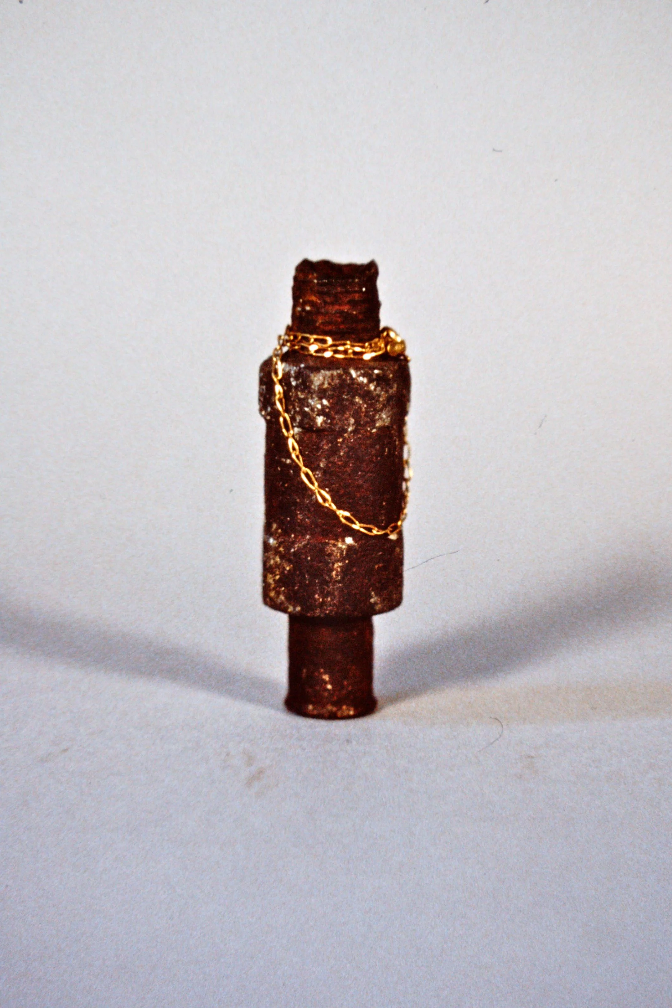 Venus of Willendorf 1995 Rusted pneumatic fitting, gold chain 3" high