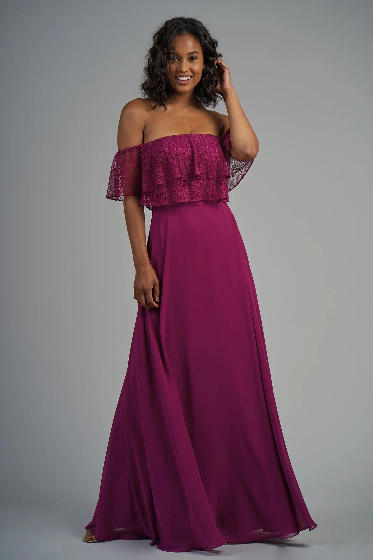 B213013 - Beautiful lace and poly chiffon floor length bridesmaid dress with a strapless neckline and short lace fabric that fits around the arms. Layered flowy bodice and flowy skirt to complete the look. Available in 22 colors