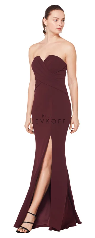 1619 - Stretch Crepe strapless gown with a cut out front. Criss-cross pleating adorns the bodice. Off-center front slit. Available in 10 colors