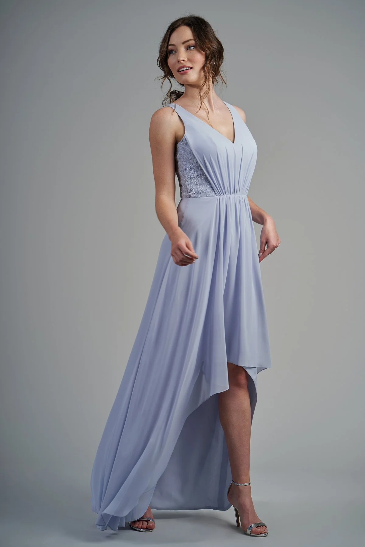 B213015 - Beautiful poly chiffon and lace high-low bridesmaid dress with a flattering V-neckline and keyhole back. Detailed gathers throughout the dress and lace detail on the sides of the bodice to complete the look. Available in 22 colors