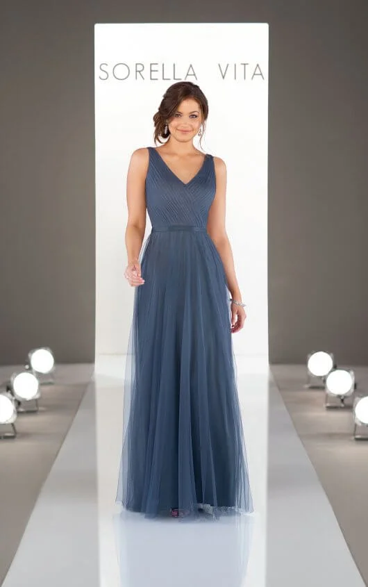 9156 - Keep it simple! This timeless bridesmaid dress is a universal classic, and the perfect accompaniment to any wedding theme. With an elegant V-neckline that elongates the frame, the Soft English Net skirt gently floats away from the body for an effortless walk down the aisle, flattering every figure in your bridal party. Available in 9 colors