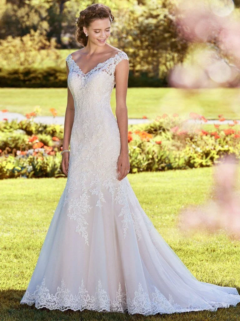 Nancy - Shimmering lace motifs cascade over tulle in this classic fit-and-flare wedding dress, accenting the illusion V-neck, illusion cap-sleeves, and illusion scoop back. Finished with covered buttons over zipper closure. Available in plus size. Available in: Ivory, Ivory/Soft Blush