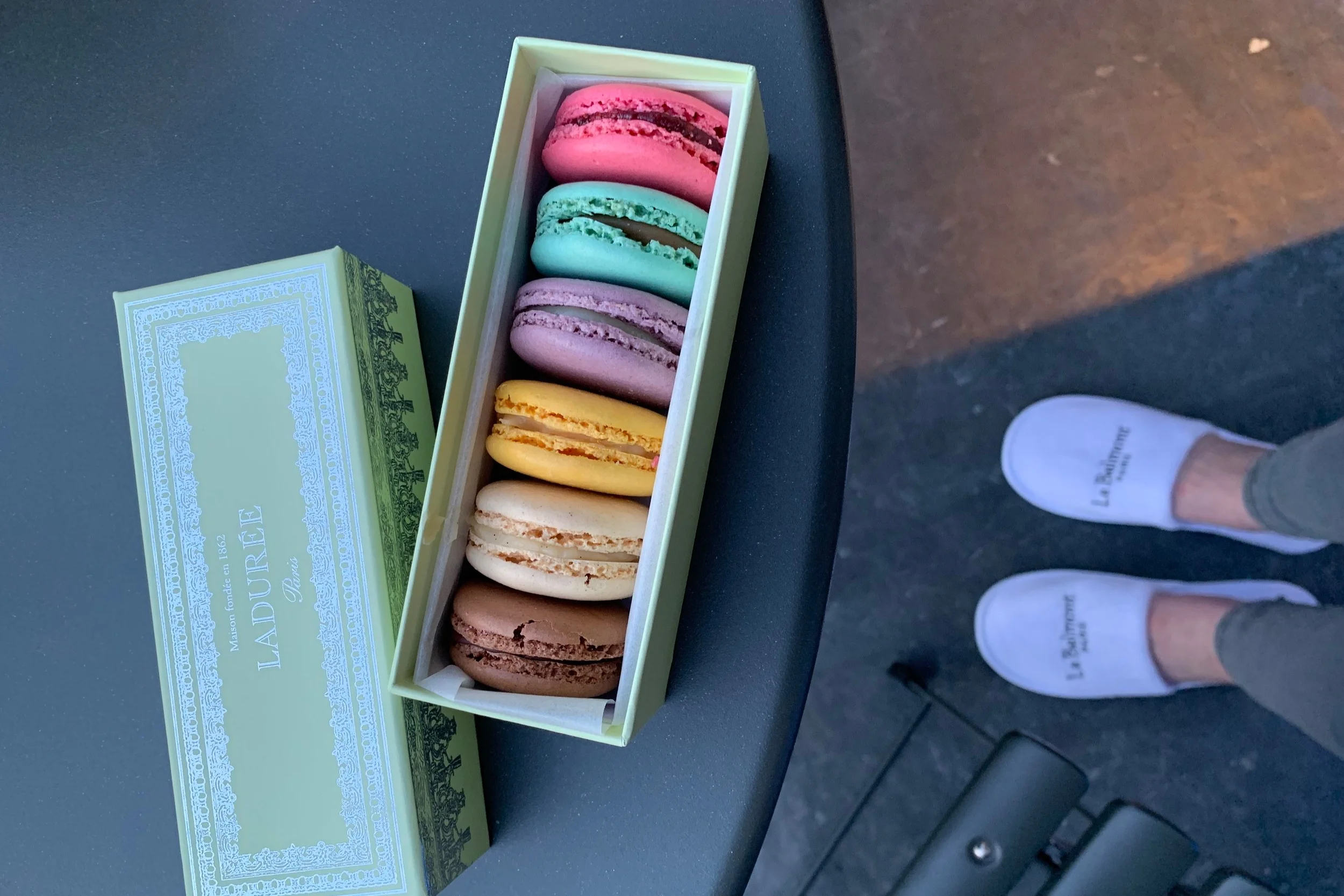 Enjoying some famous Laduree macarons on our hotel balcony.