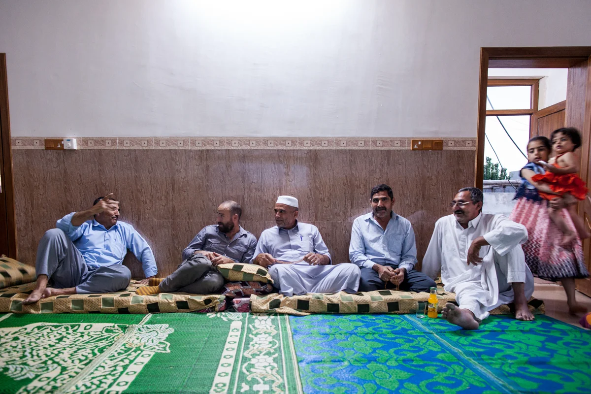 Extended family talks before dinner in their home in Northern Iraq, where they fled to in 2014 after ISIS took their home in Southern Iraq (May 2016).