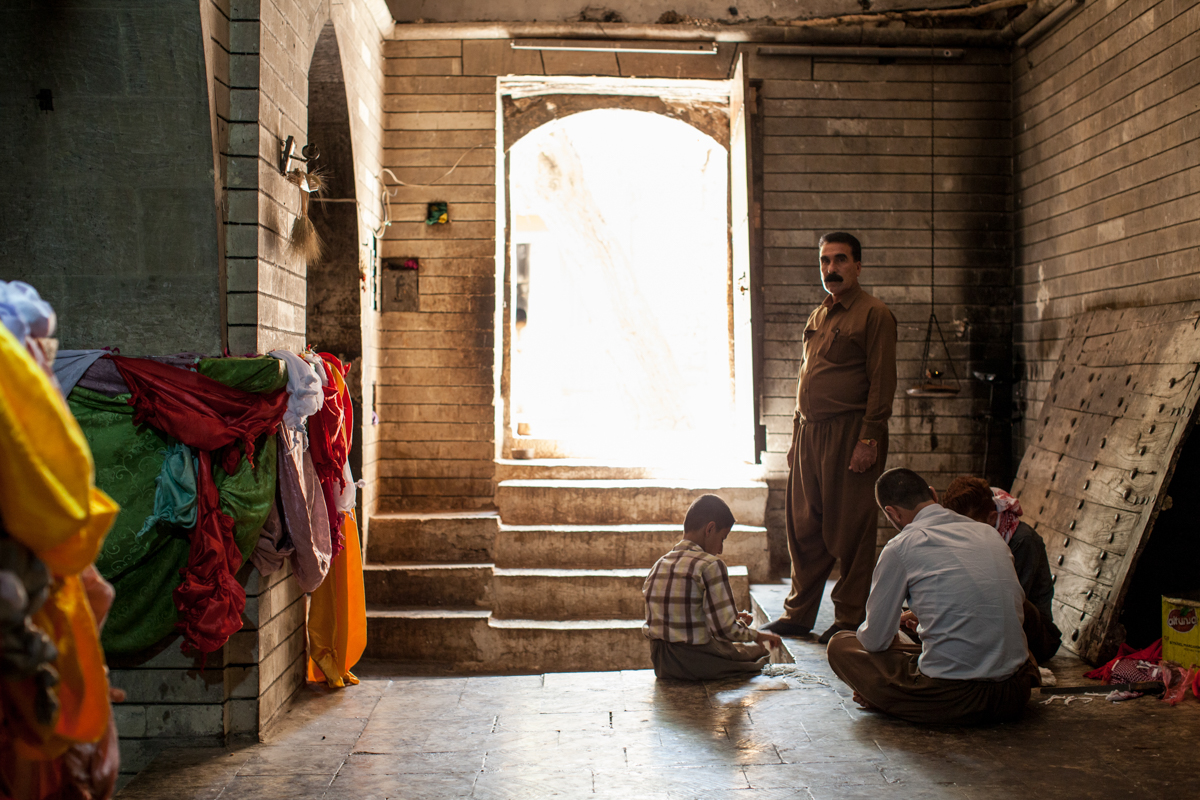  Man with mustache, assistant to Baba Sheikh, the religious leader of the Yazidi people, stands barefoot at Lalish (2016). 