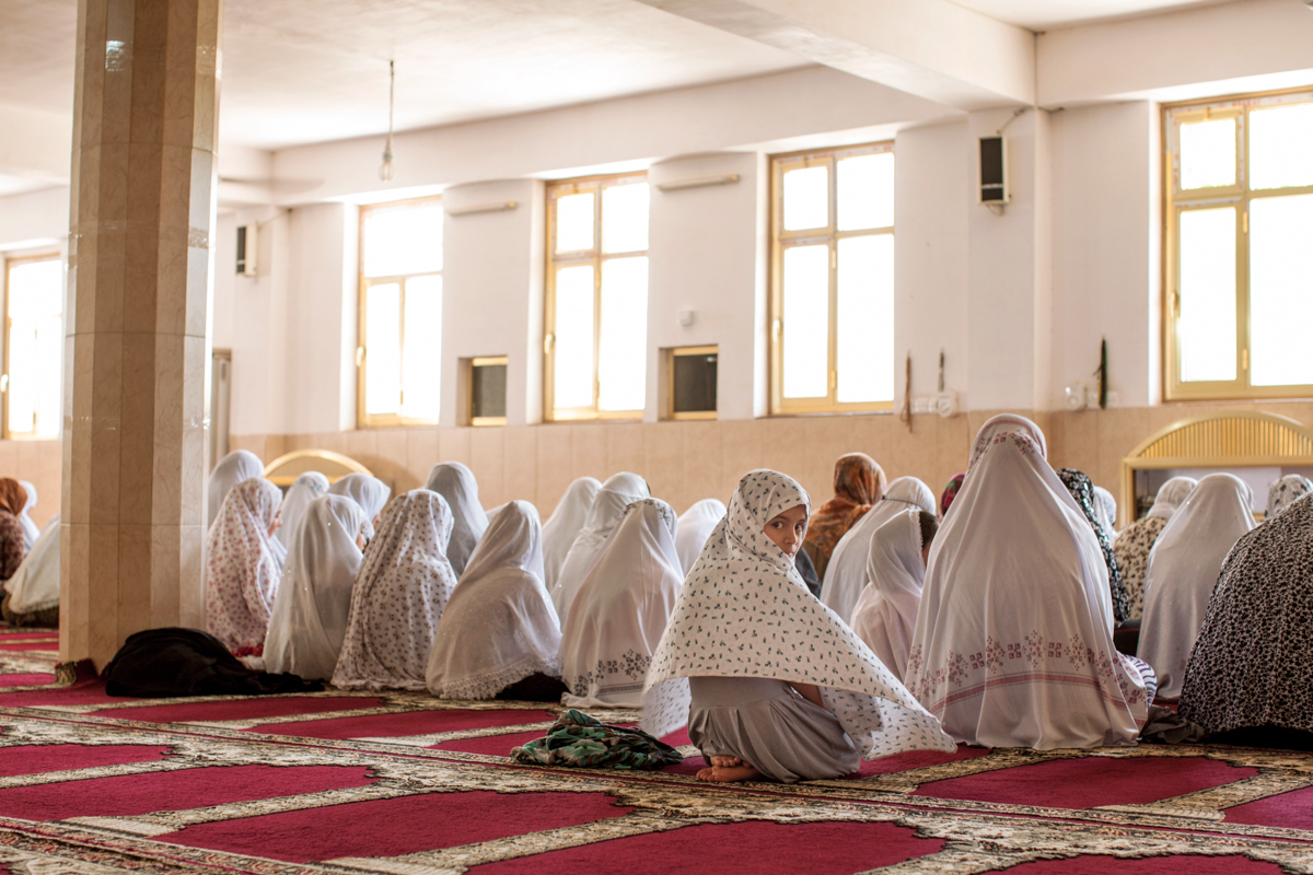  Women listen to the imam preach on the speaker during Friday prayers from the basement of a mosque in Soran, Iraq ( 2016). 