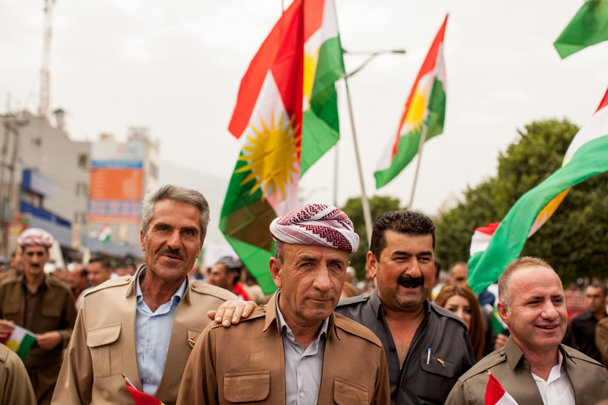  Men march at a Kurdish parade in support of their country (2016). 