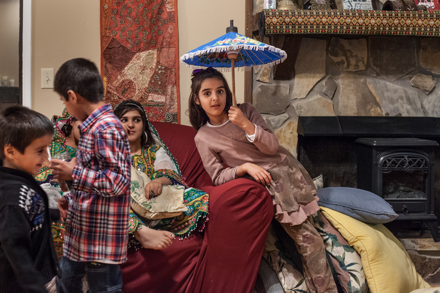  Saadia, and Afghani refugee, poses beneath an umbrella at a friends home in Buford, Georgia. (2014). 