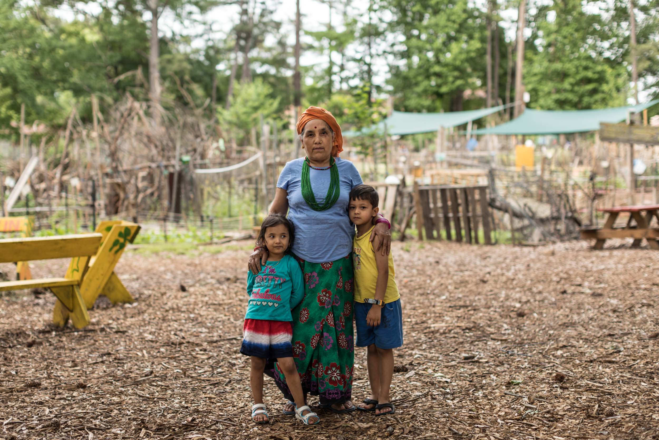  Nepalize refugee woman and her children inside the Friends of Refugees community garden in Clarkston, Georgia.  Shot for The Guardian, (May 2017)   This small town in America's Deep South welcomes 1,500 refugees a year   