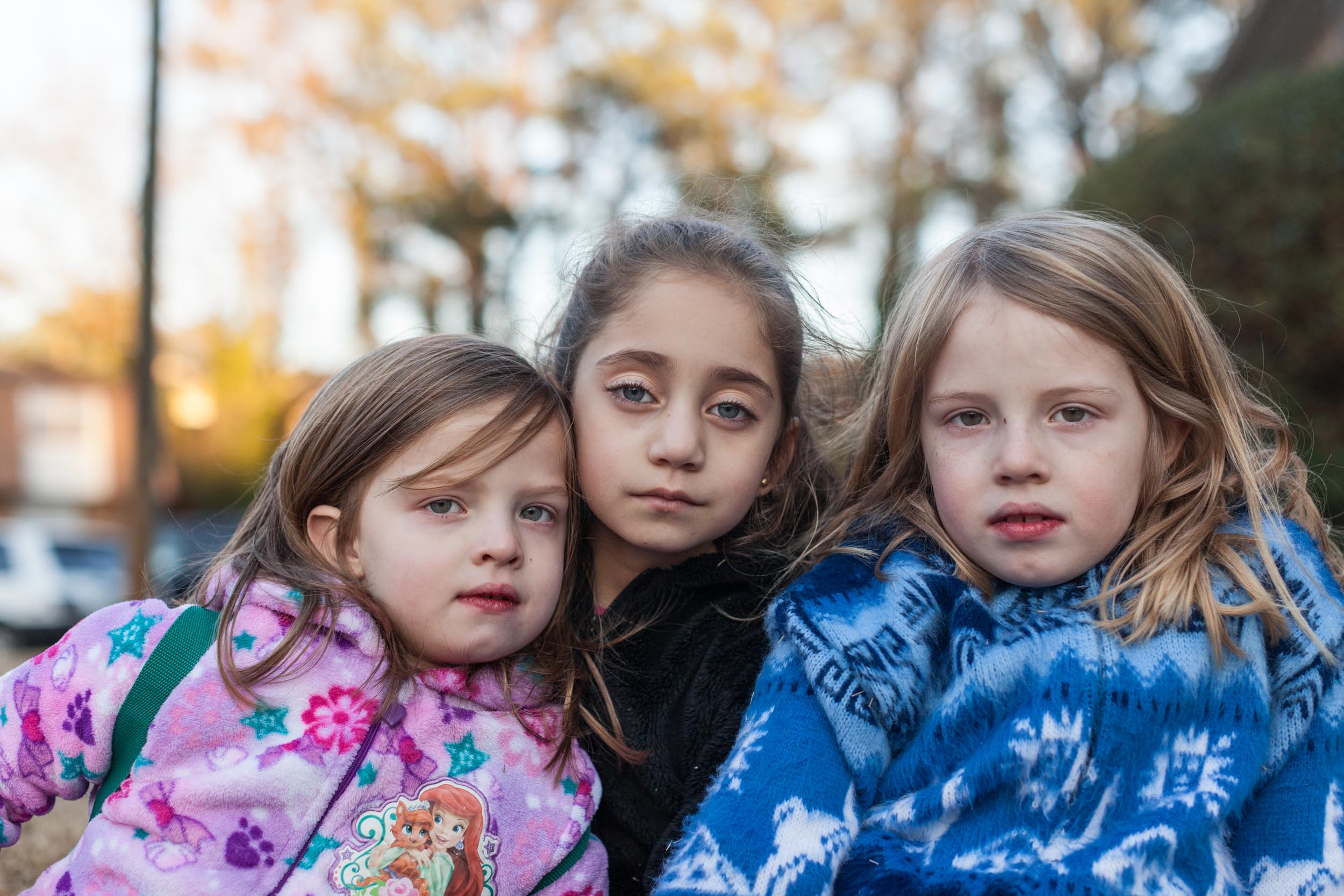  Joanna (center), a Syrian Kurd 19 months after her arrival to America sits with her neighbors, Maddie and Hannah, now best friends (2015). 