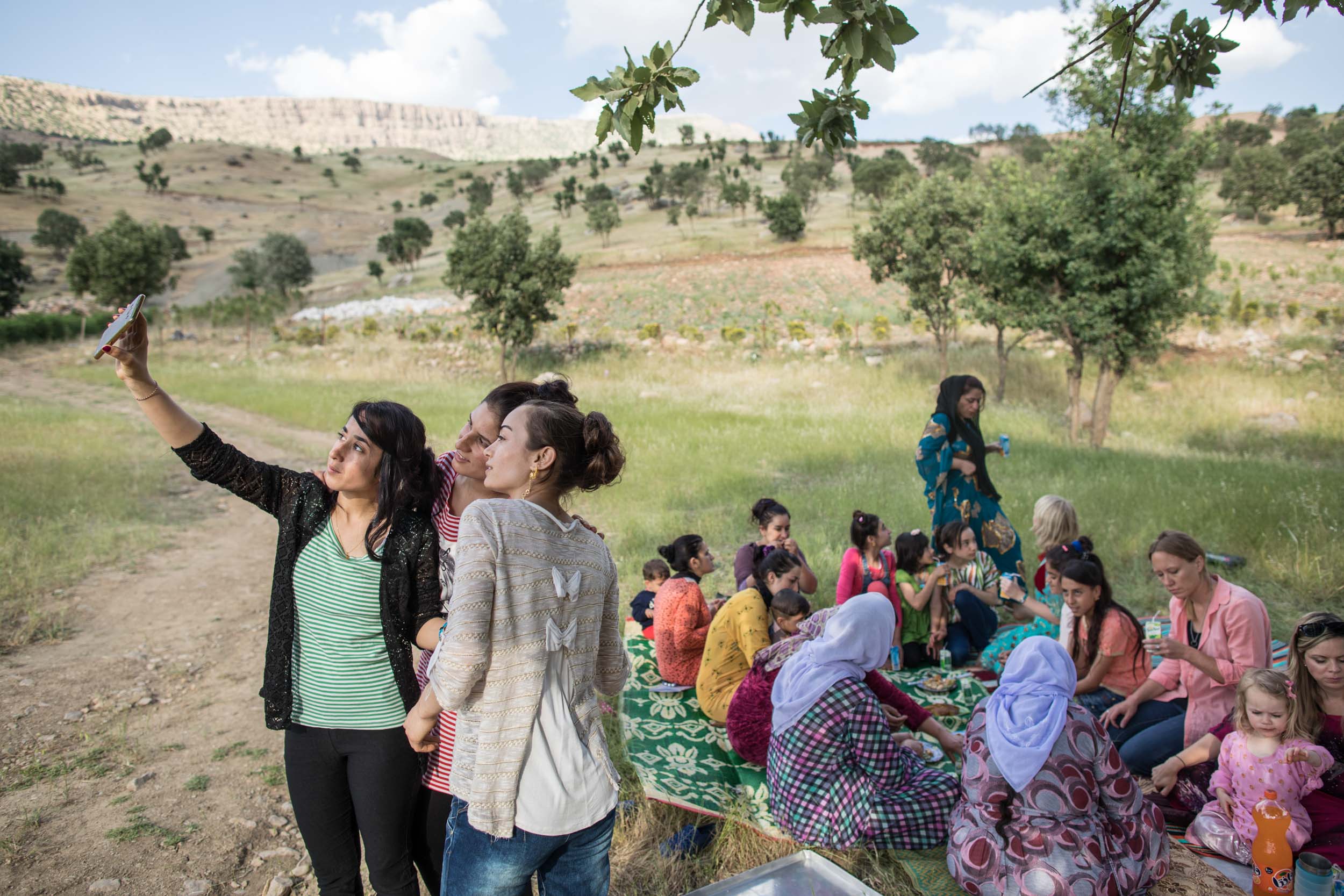  Yazidi teenage girls host a party on the grounds at their camp in Northern Iraq. The families at the camp prohibit the girls, and not the boys, from attending the local school built for IDP in the area (2016). 