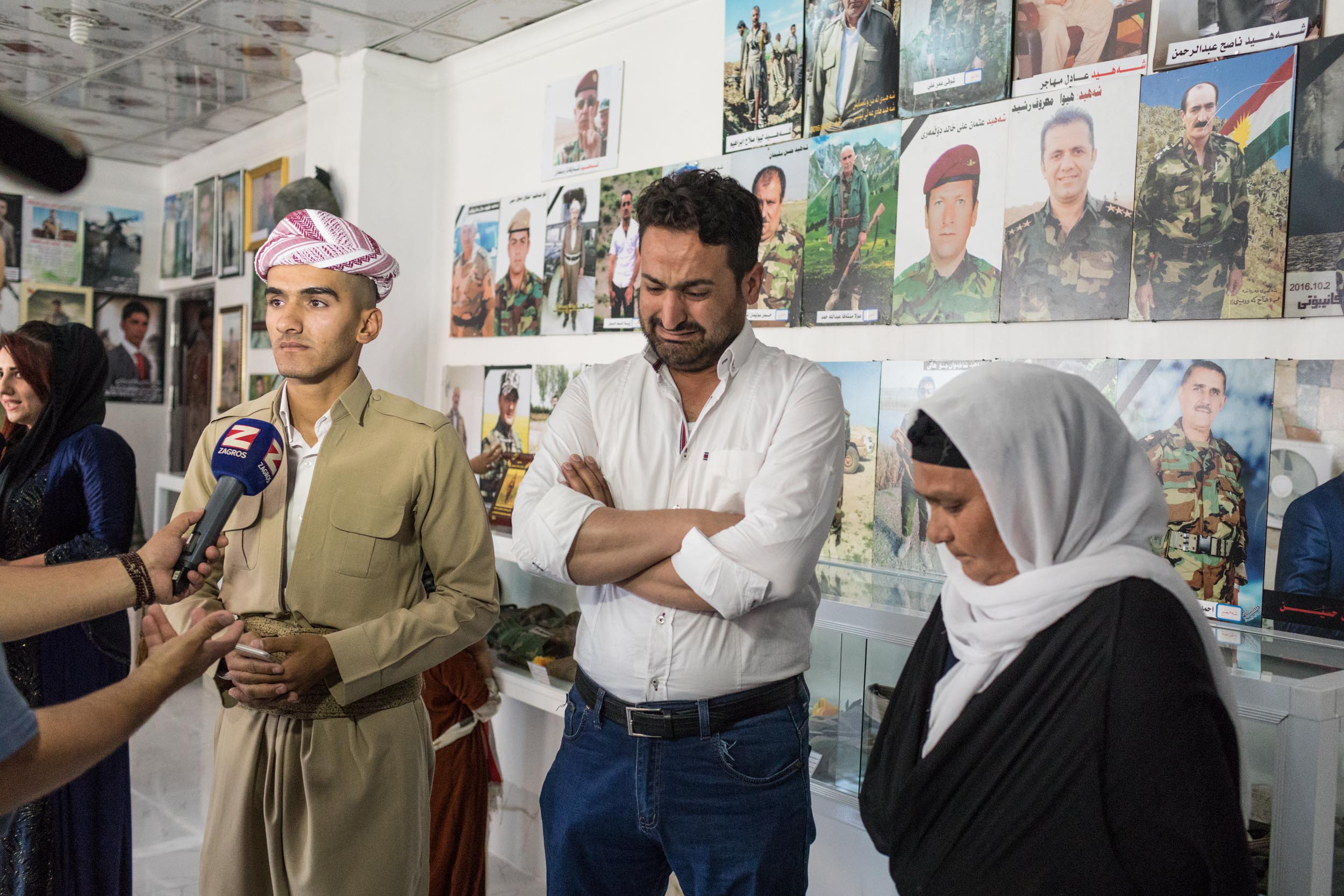  Family grieves the loss of a family member at a Peshmerga memorial opening in Soran, Iraq (May 2017). 