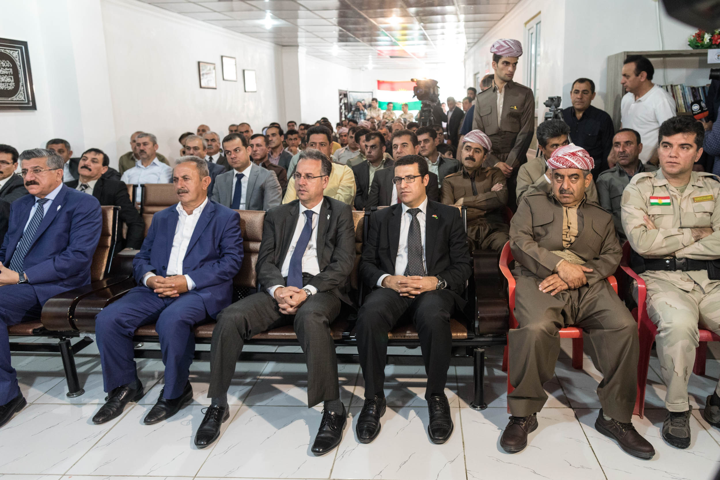  Men listen to the Mayor Krmanj Ezzat Dargali speak at a local town meeting in Soran, Iraq (2017). 