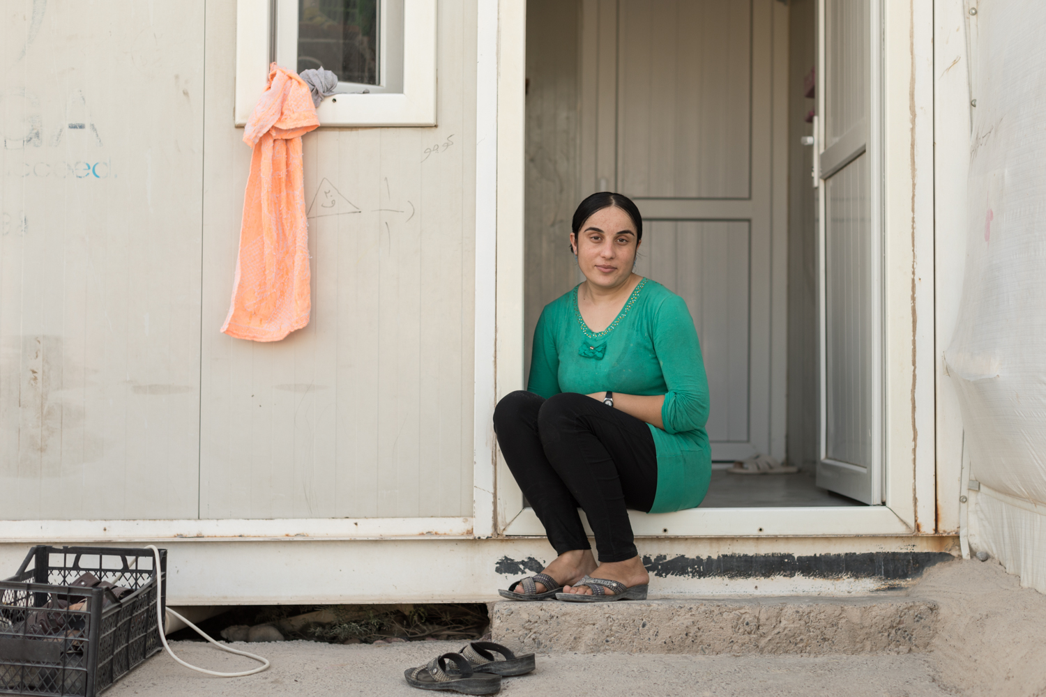  Nofa, a 24-year-old Yazidi woman who survived weeks living as an ISIS sex slave, sits outside her shelter at the 19,000 member Rwanga Community Camp in Qadiya, Iraq. Shot for Grazia Magazine UK (August 2017). 