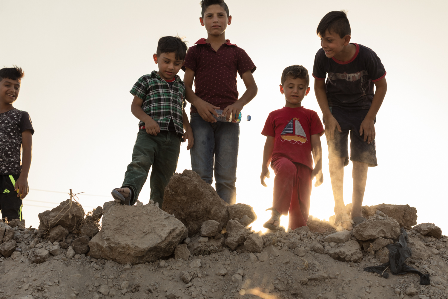  Yazidi boys from Sinjar play on a hospital construction zone near their camp in Soran, Iraq (September 2017). 