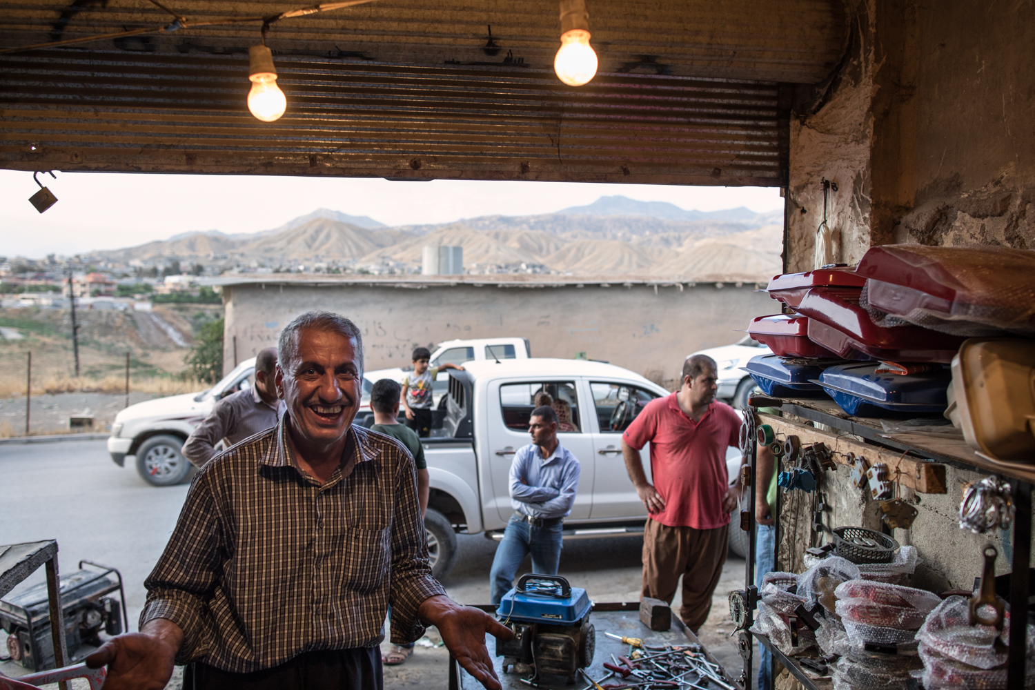  Kudish mechanic inside his garage at dusk. Soran, Iraq (July 2017). 