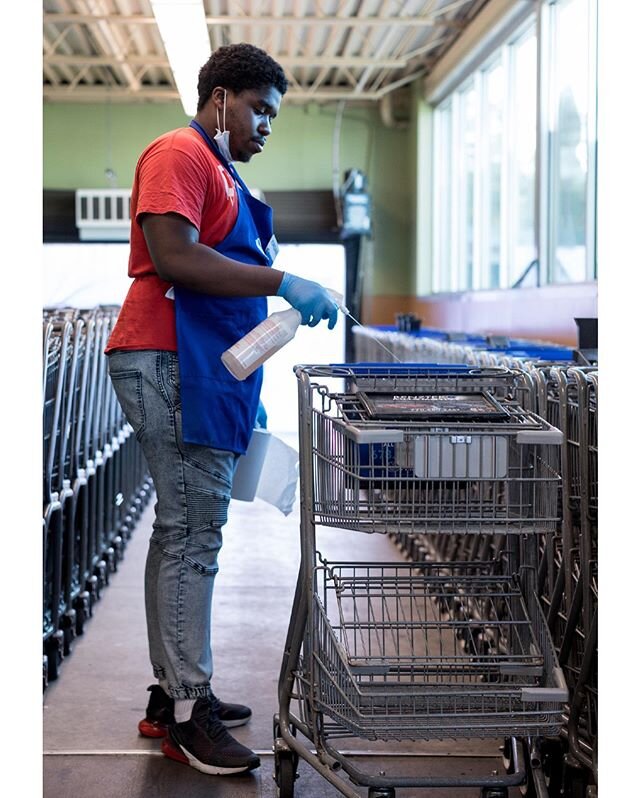 Employee wipes shopping cart at a supermarket Loganville, Georgia on Saturday, April 4 as part of the store&rsquo;s effort to keep employees and customers safe from coronavirus.