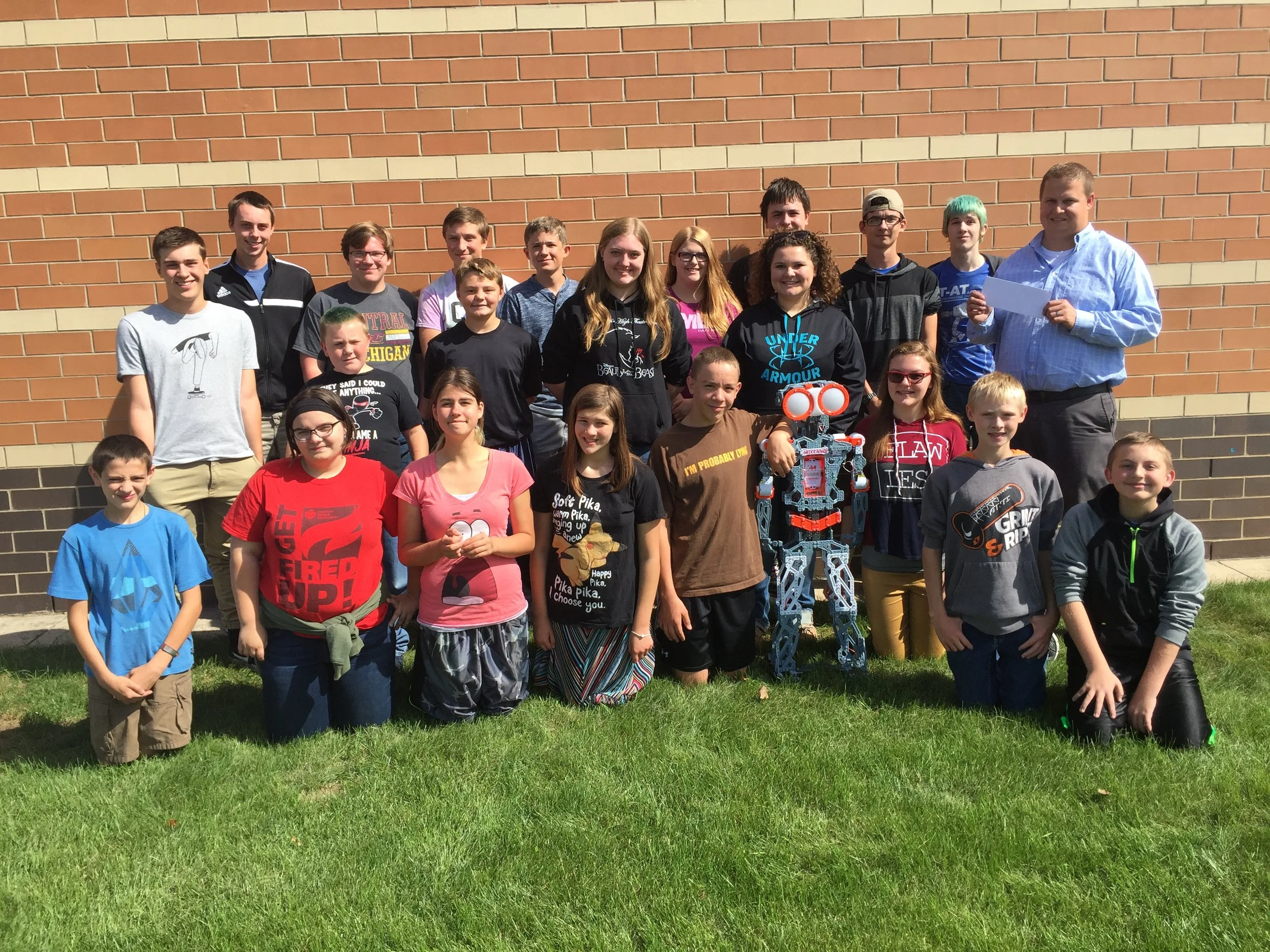 Some of our high school and middle school members accepting the donation from Coopersville Women Who Care!