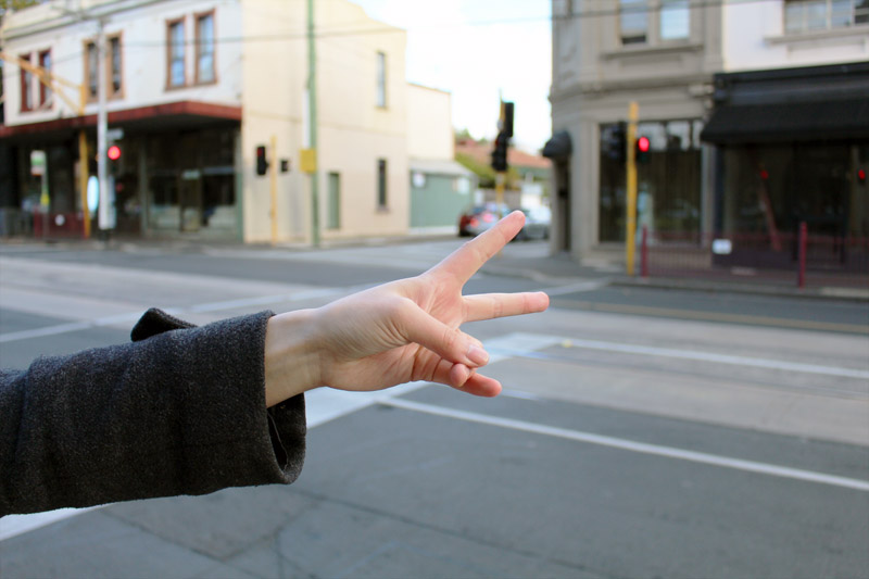 Waiting for our tram feat. Milly's peace sign 