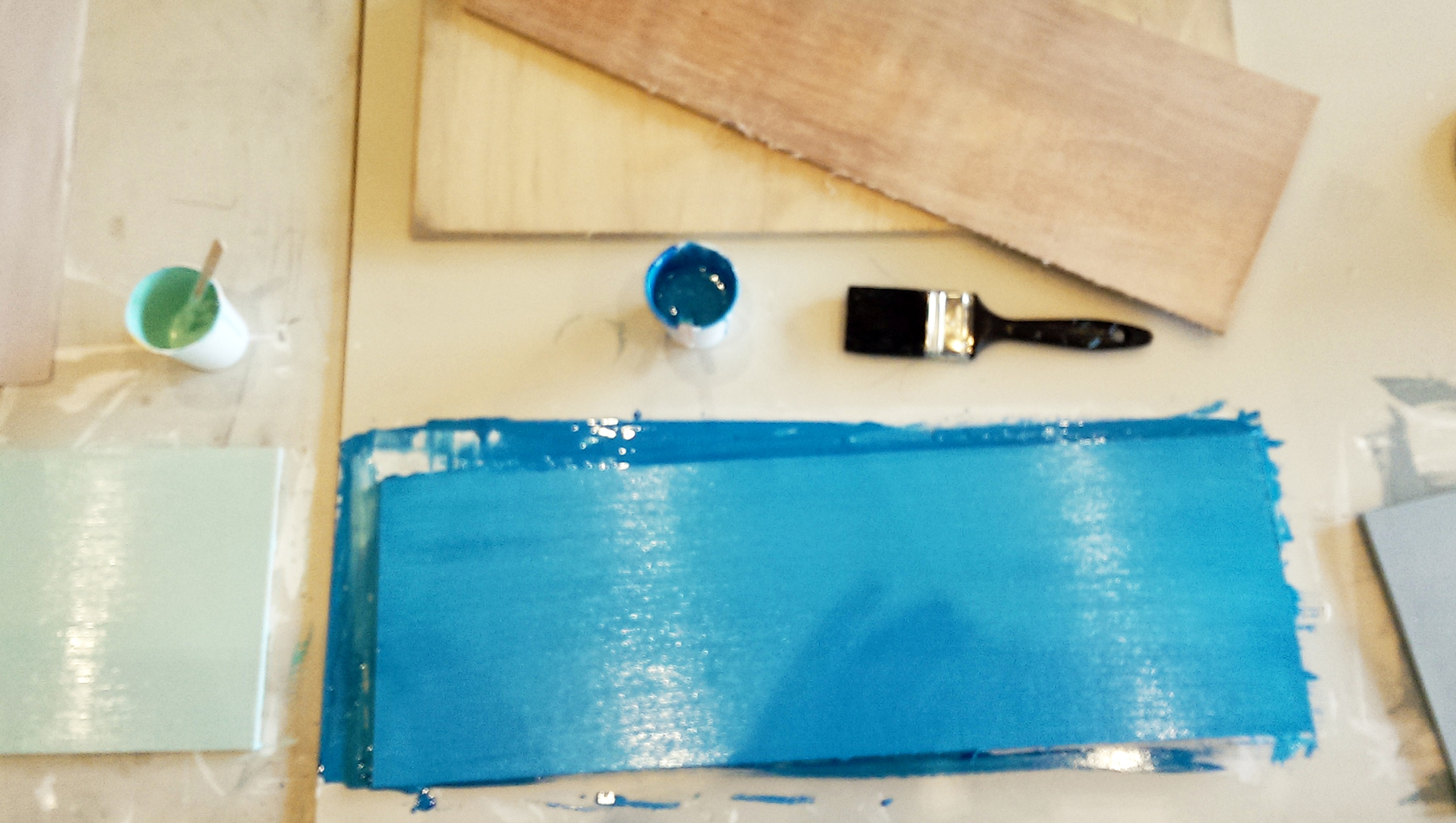 Piece of wood painted in a coat of blue 