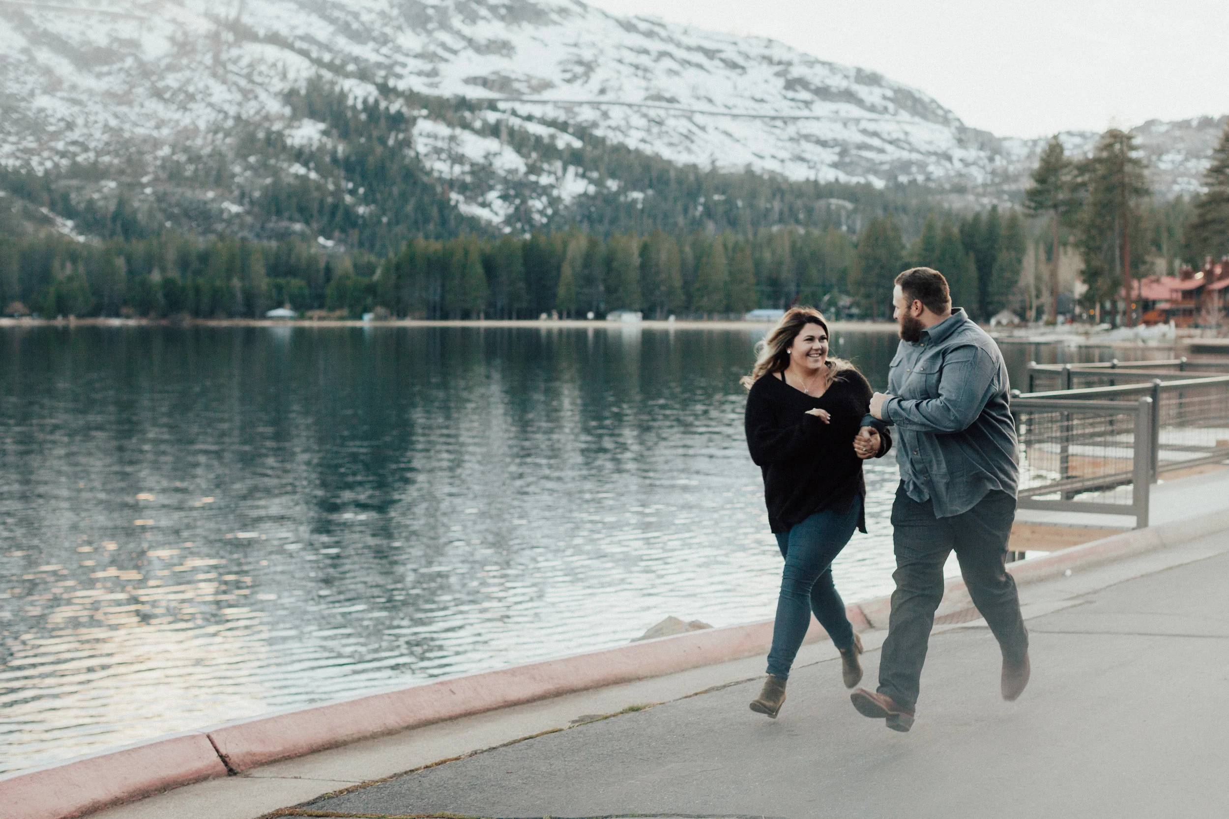 Running hand-in-hand by the lake.
