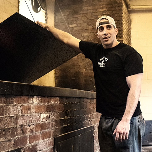 Martin's Pitmaster Jeremy Jordan shows how whole hogs are smoked at the Downtown Nashville location