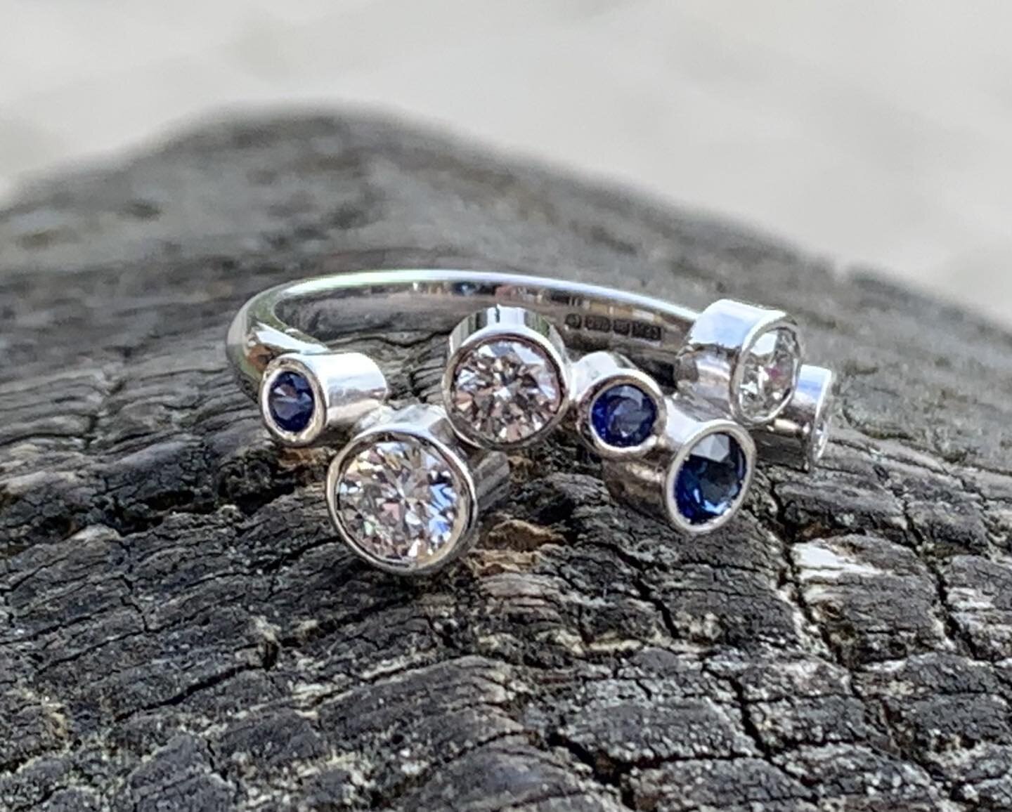 18ct white gold sapphire and diamond engagement ring made to customers design .