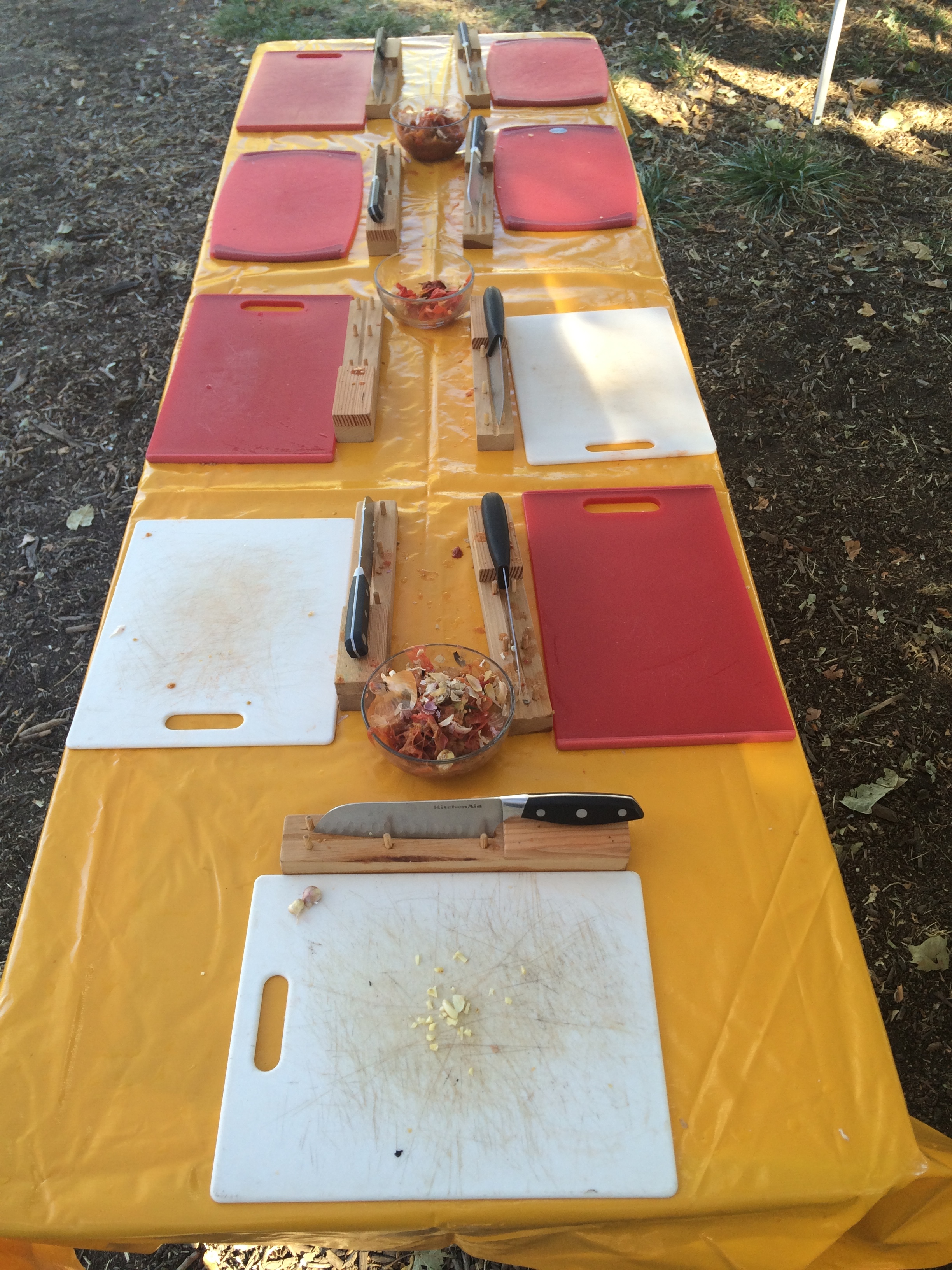 Students learn knife skills in the outdoor kitchen
