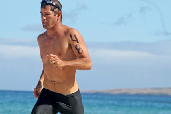 Jason Freitas finishes first in the Greg Cameron Firemen’s Fund Fun Run and Swim on Sunday at the Hapuna Beach State Recreation Area. (JR De Groote/West Hawaii Today)