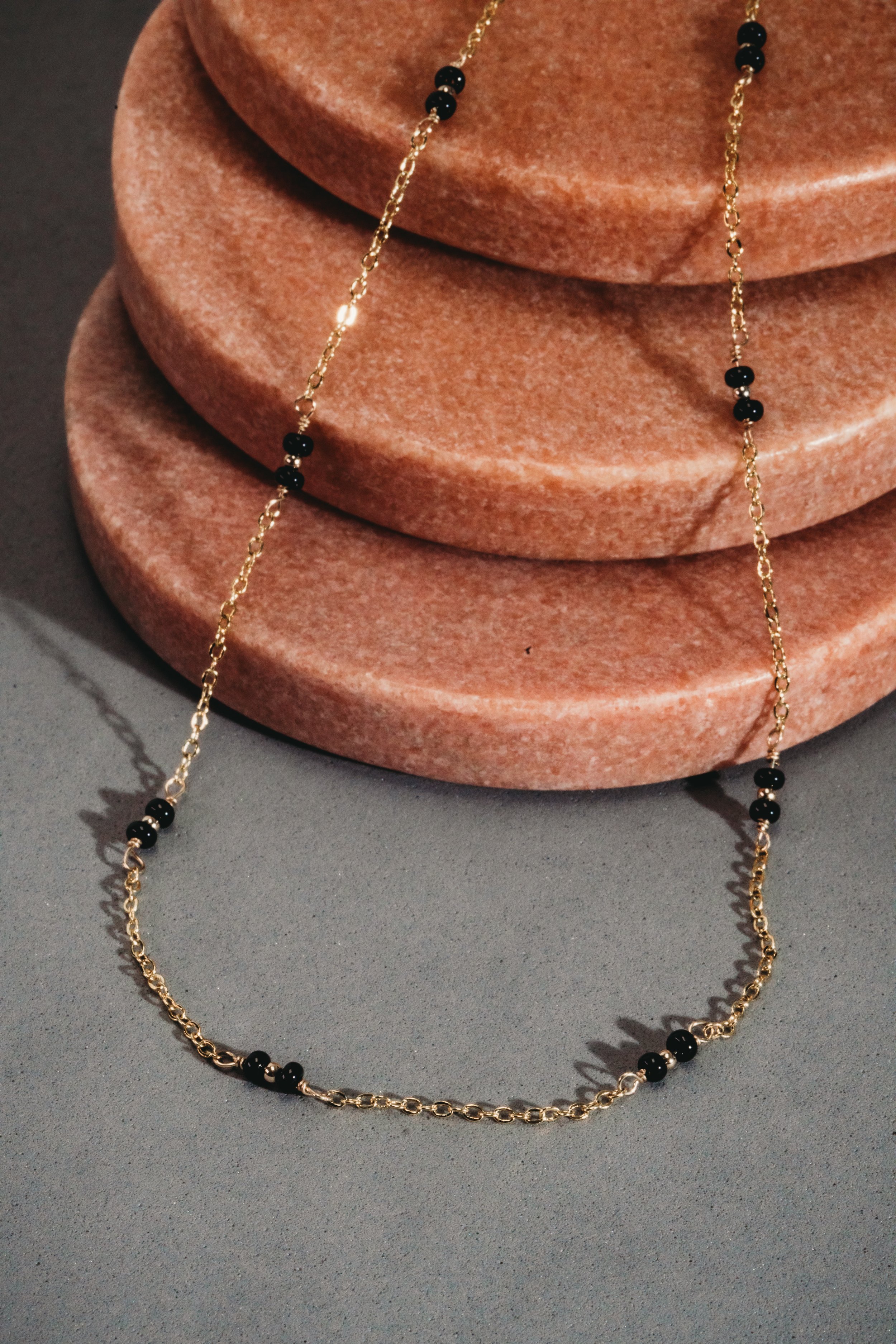 Jewelry product photography styled with props. Macro with off-camera flash
