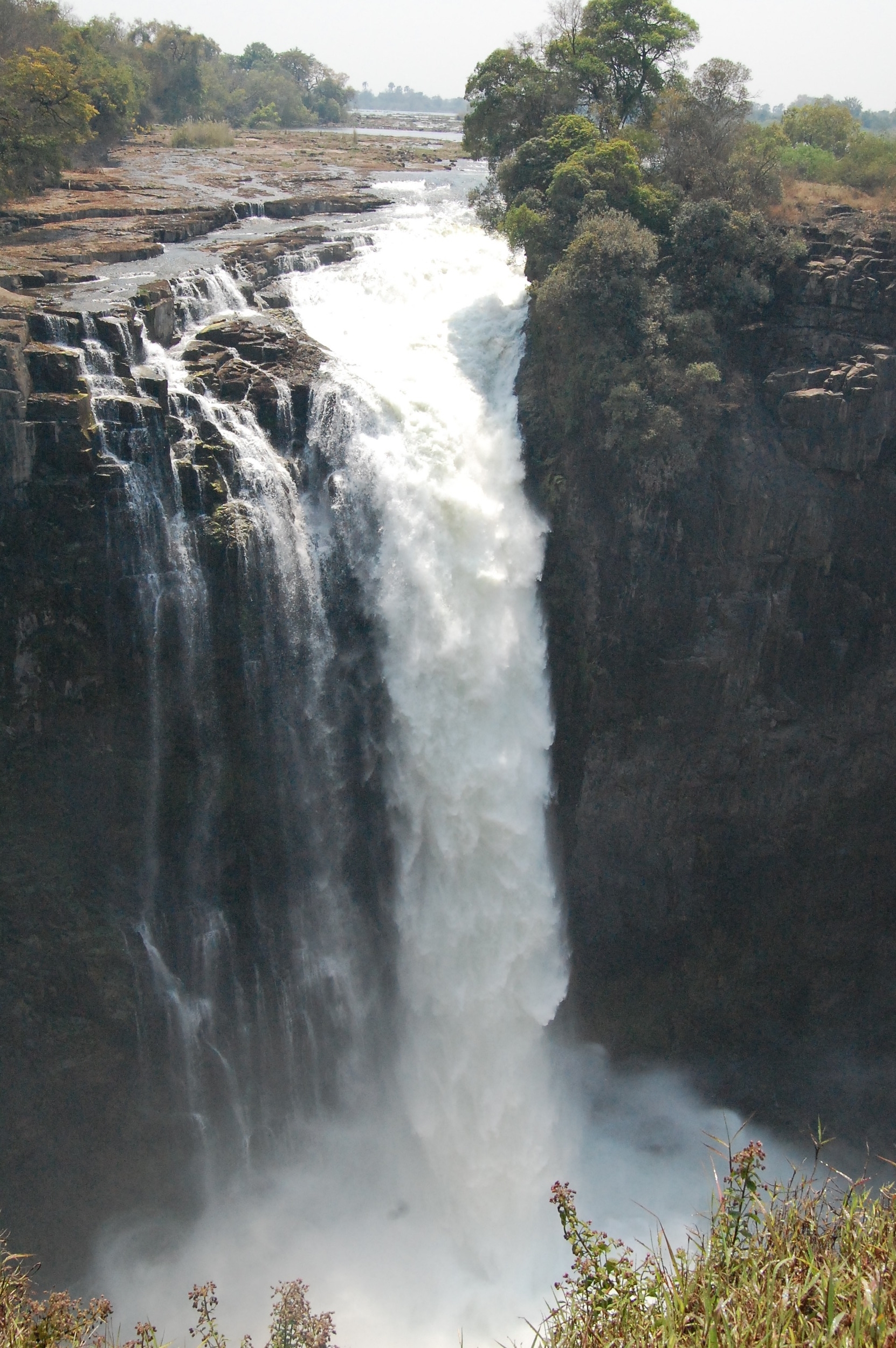  Victoria Falls, AKA "The Smoke that Thunders," is the largest waterfall in the world. &nbsp;It separates Zambia and Zimbabwe. &nbsp;You can see the waterfall from the Zimbabwe side while walking through the  Victoria Falls park . &nbsp; 