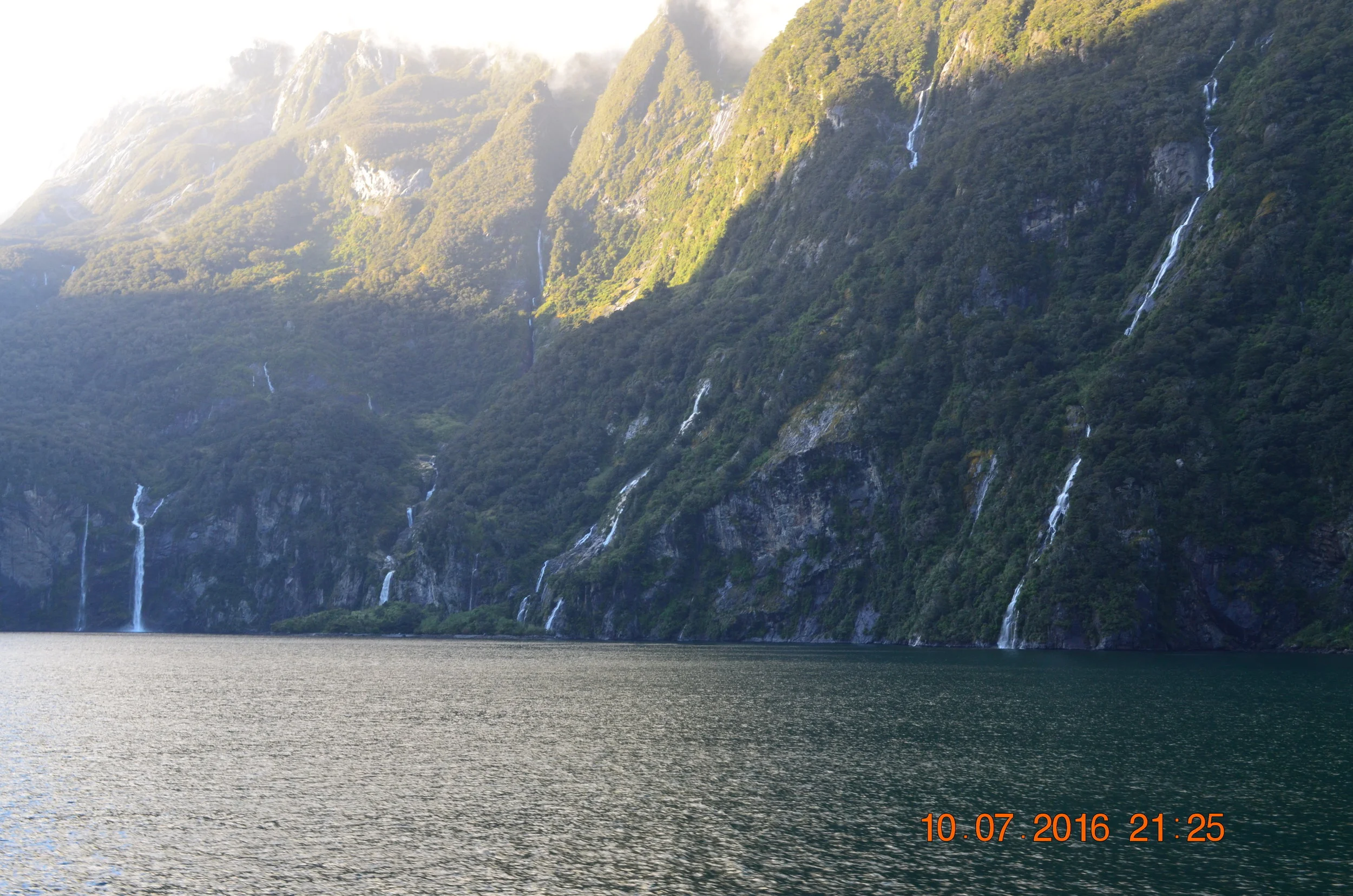   Milford Sound  is a rainforest and considered one of the wettest places on earth. &nbsp;After a rain, thousands of waterfalls cascade down the cliffs. &nbsp;Waking up to this view was nothing short of spectacular. &nbsp;Once the rain stops, the wat