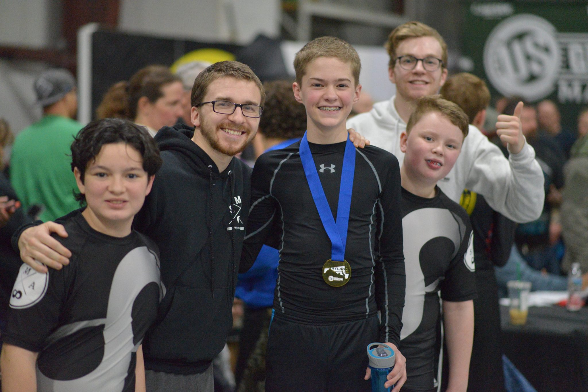 Coach Seth and Coach Ray with their students at a BJJ competition