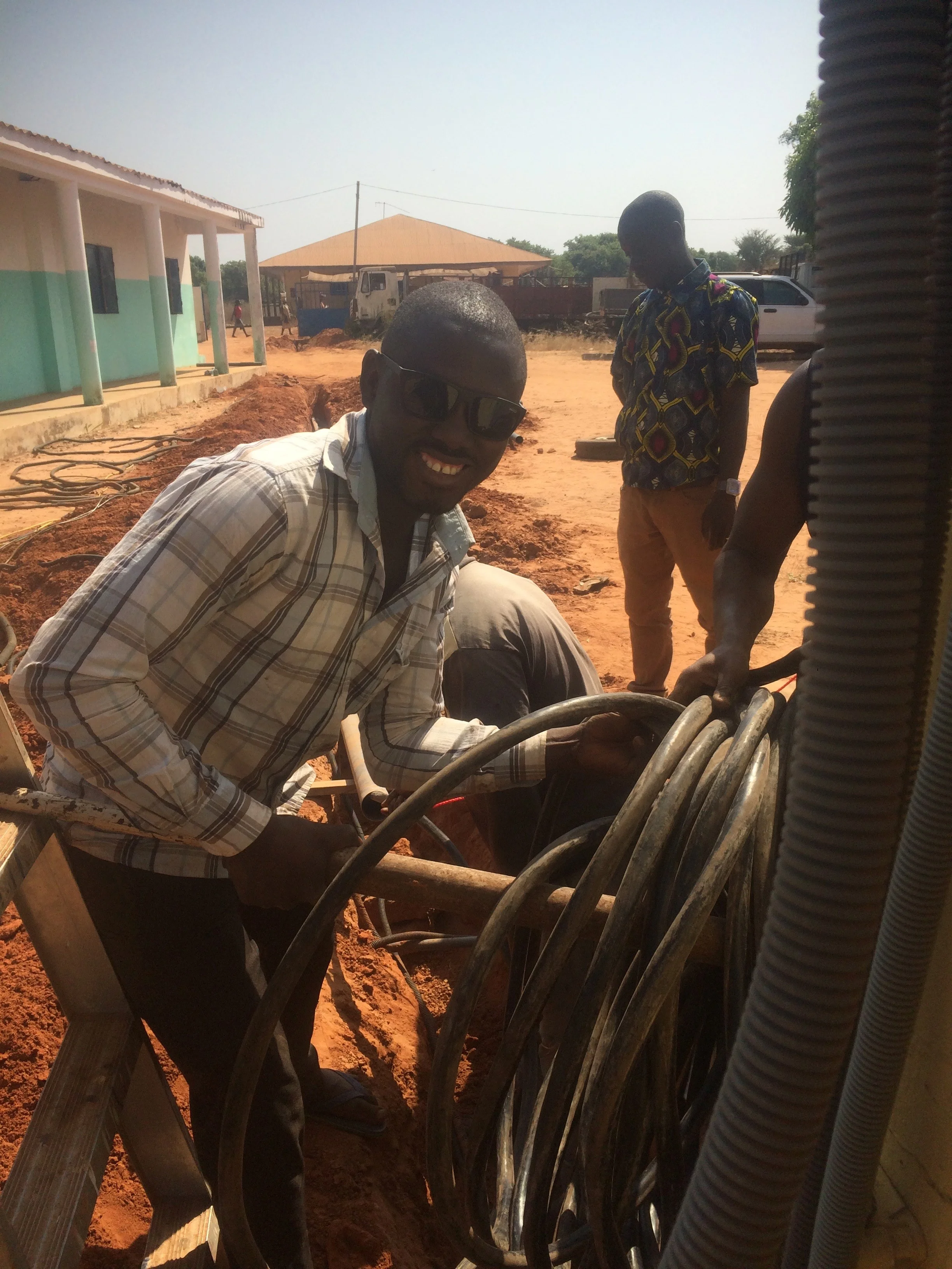 Cirilo hard at work, digging a trench for the eletrical line to give the Welding department power.