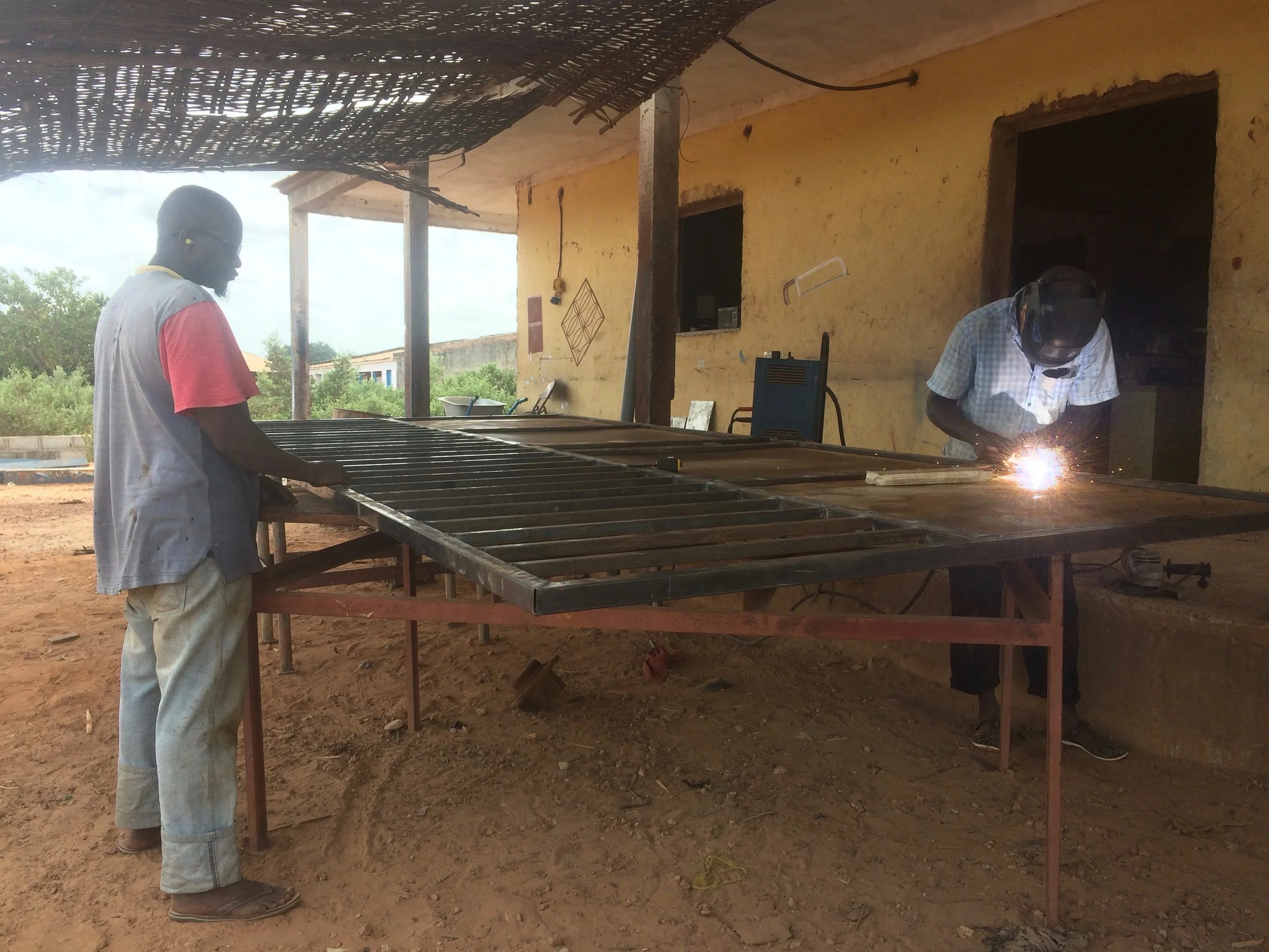 Putting the finishing welds on a large metal gate.