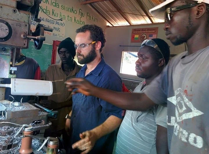 Jason showing the students a new machine.