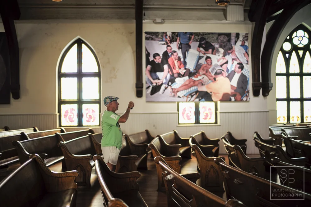 A man photographs the exhibition of sports photographer, and one of the festival's featured artists, Walter Iooss called, "The Sporting Life," at The Haven in downtown Charlottesville, Va., on Saturday, June 13, 2015. (Photography by Scott P. Yates)