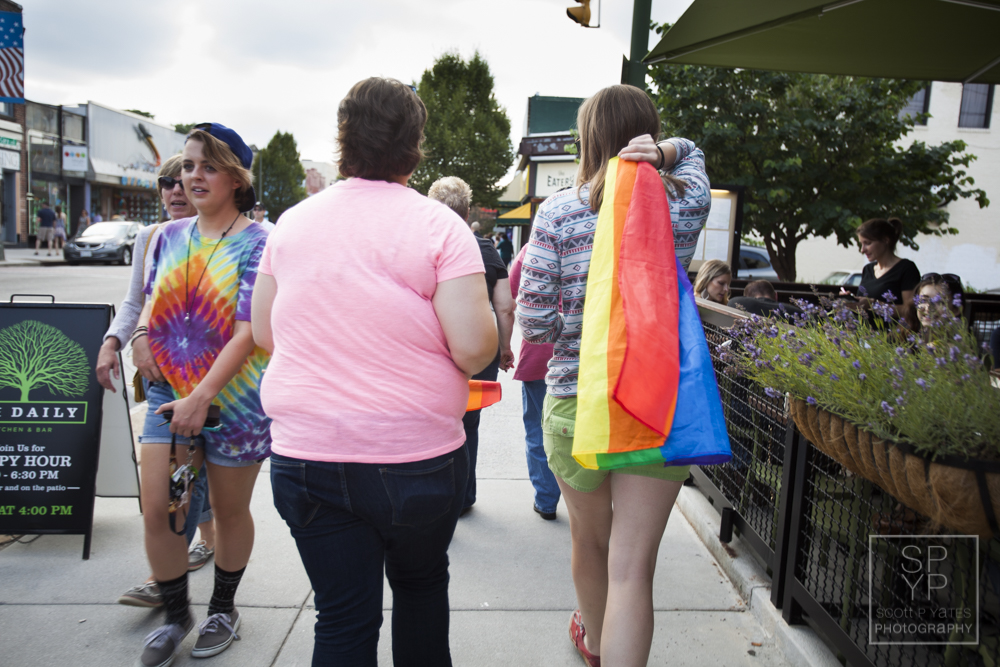 A woman walks along Cary Street in Richmond with a colorful pride flag after a press conference at the Byrd Theatre that celebrated the Supreme Court's decision to legalize same-sex marriage in all 50 states.
