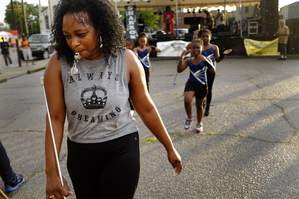 An dance and twirling instructor leads her class off stage after performing at a jazz festival in Petersburg in July 2015. Photograph by Scott P. Yates.