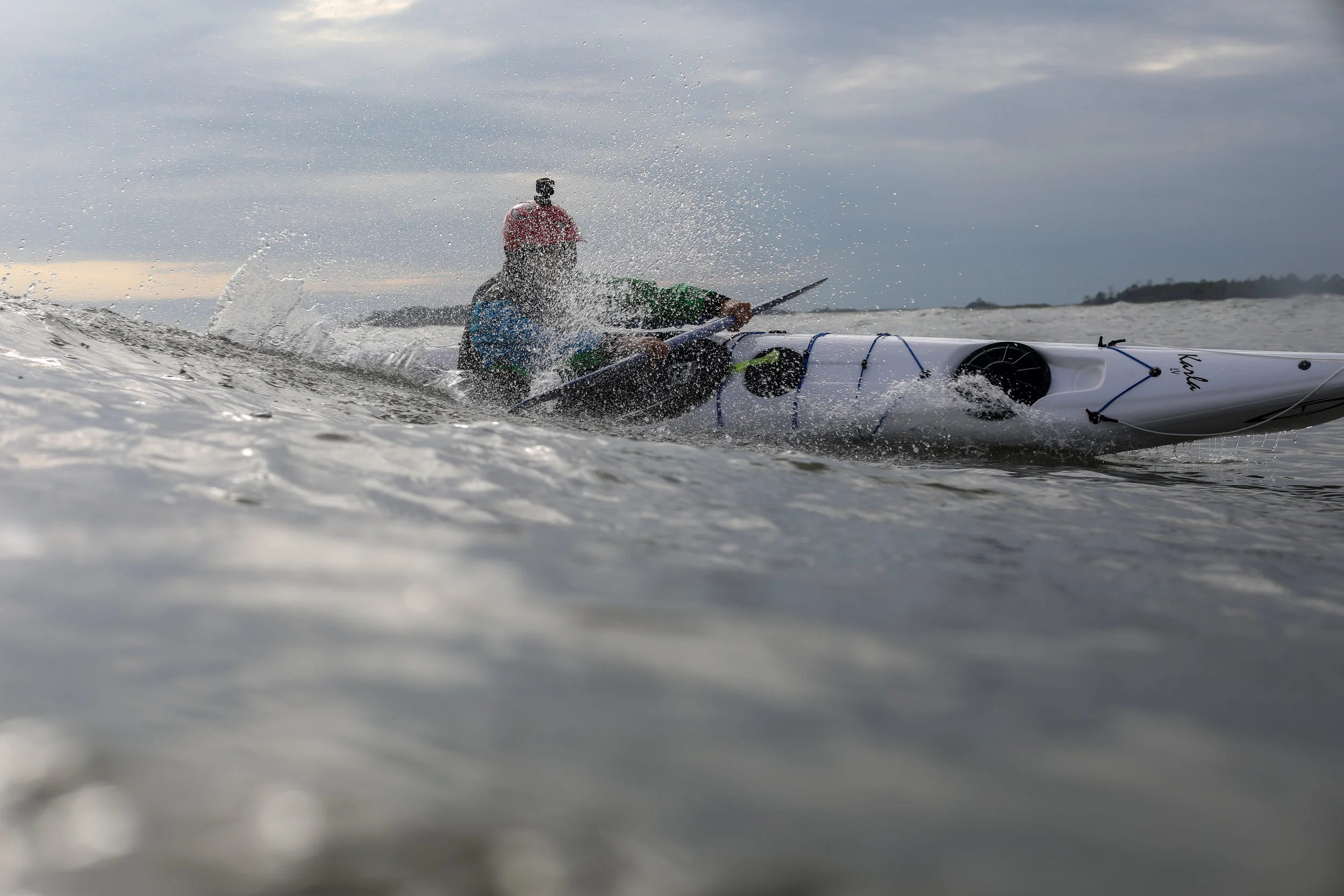Traditional style sea kayak surfing