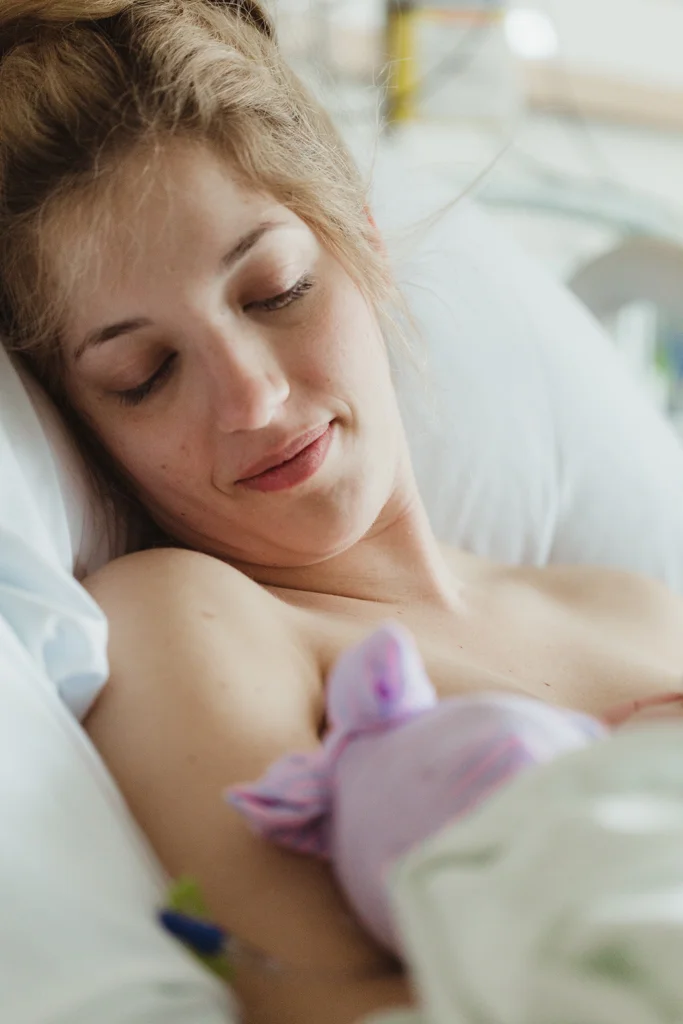 Mom admires newborn baby daughter after giving birth in Columbus Ohio