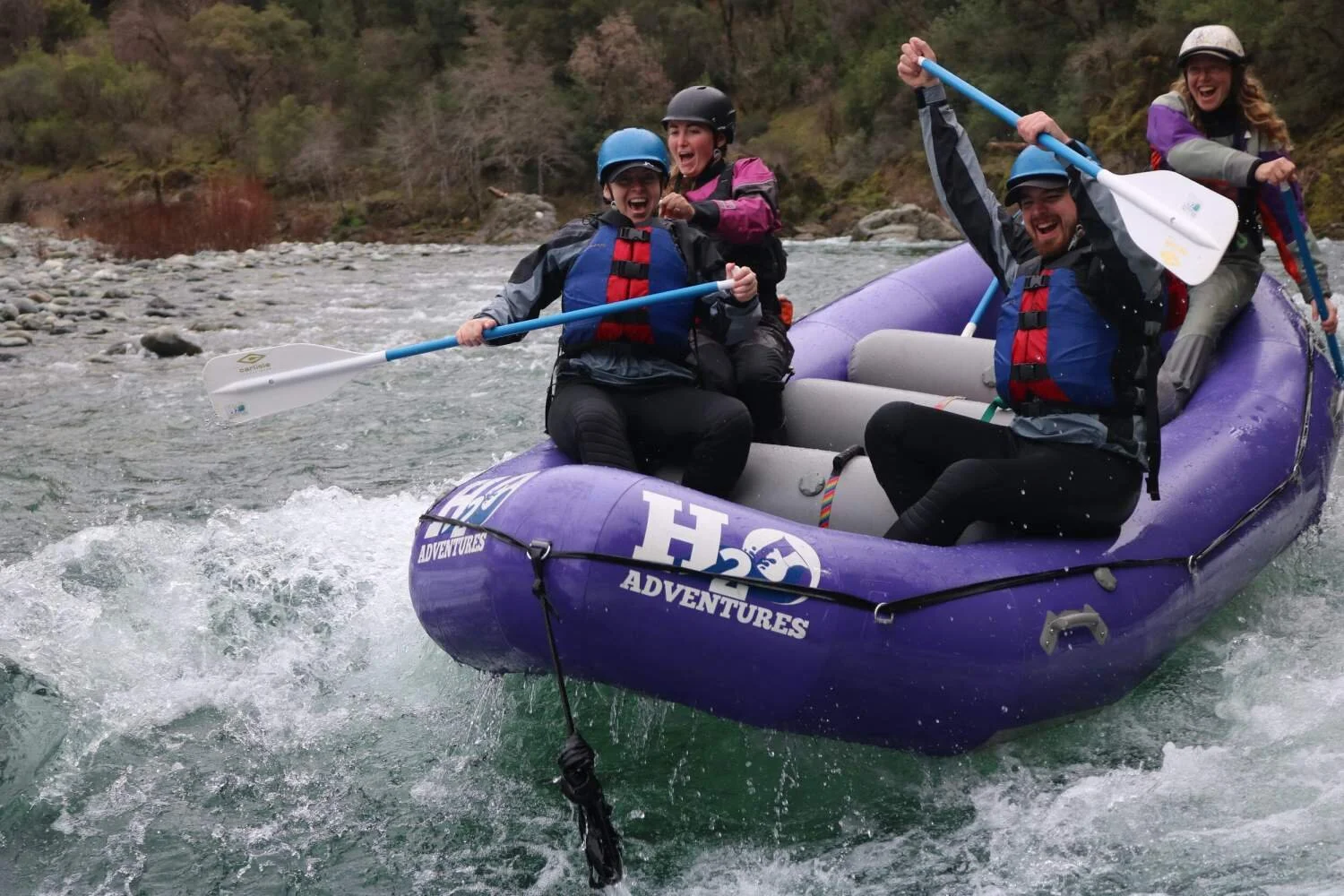 A group on a purple raft on a trip for whitewater rafting in California.jpg