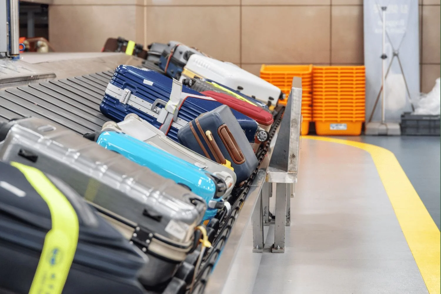 Luggage bags on a conveyor belt at an airport baggage claim area.