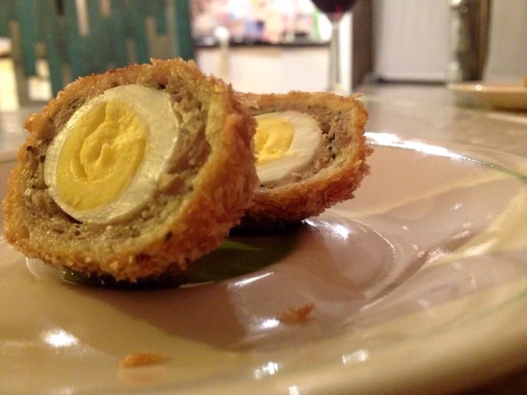 Quail egg, Quail black truffle farce, salsa verde clarified oil