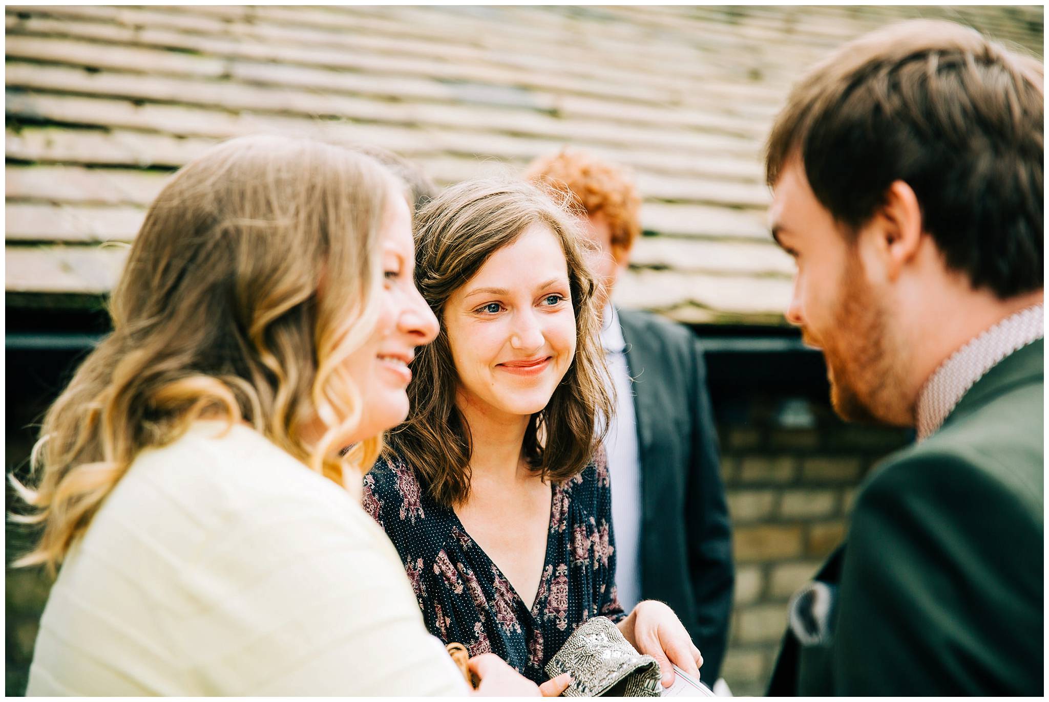 wedding guests smiling and chatting to each other