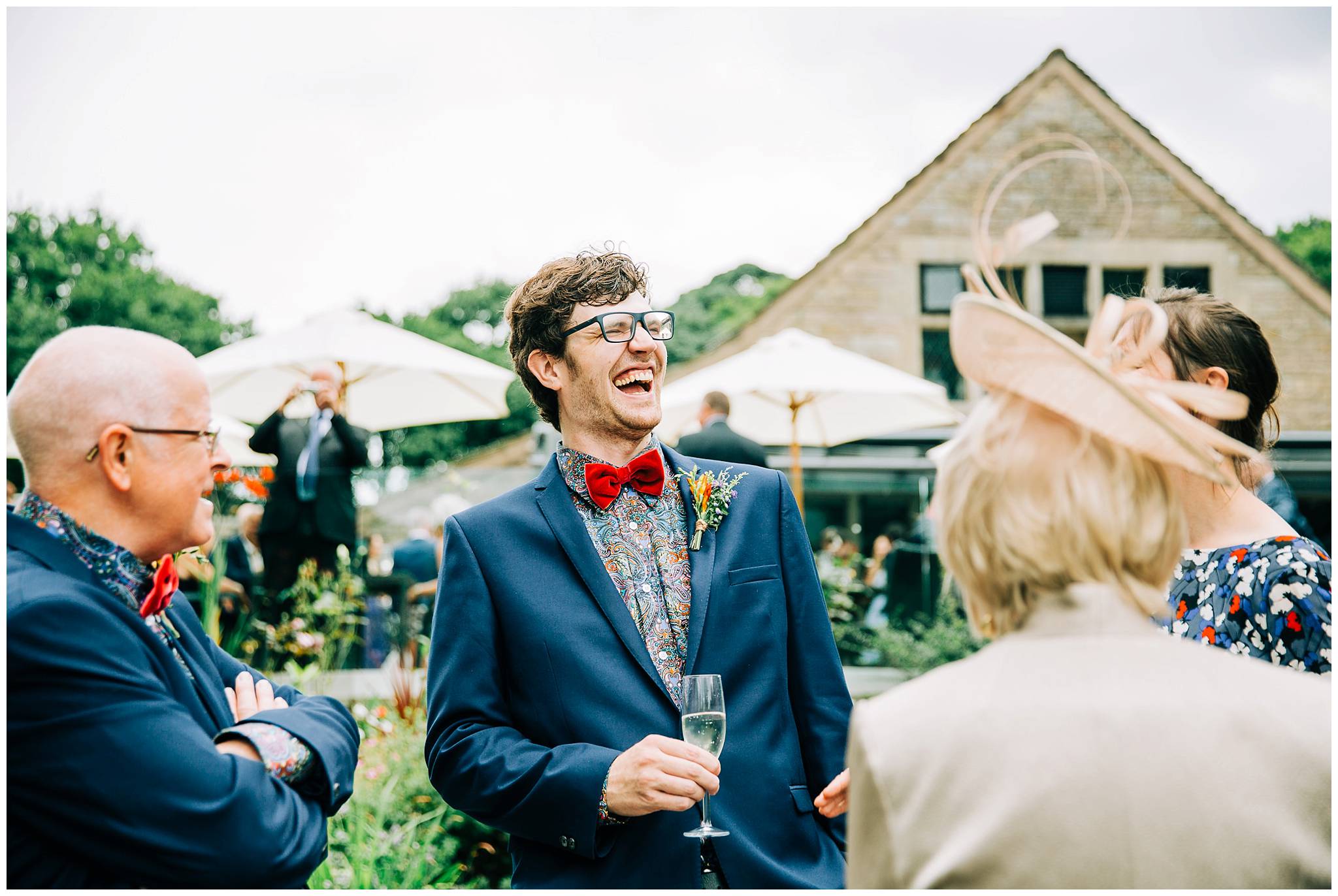 man with red velvet bow tie laughing dramatically