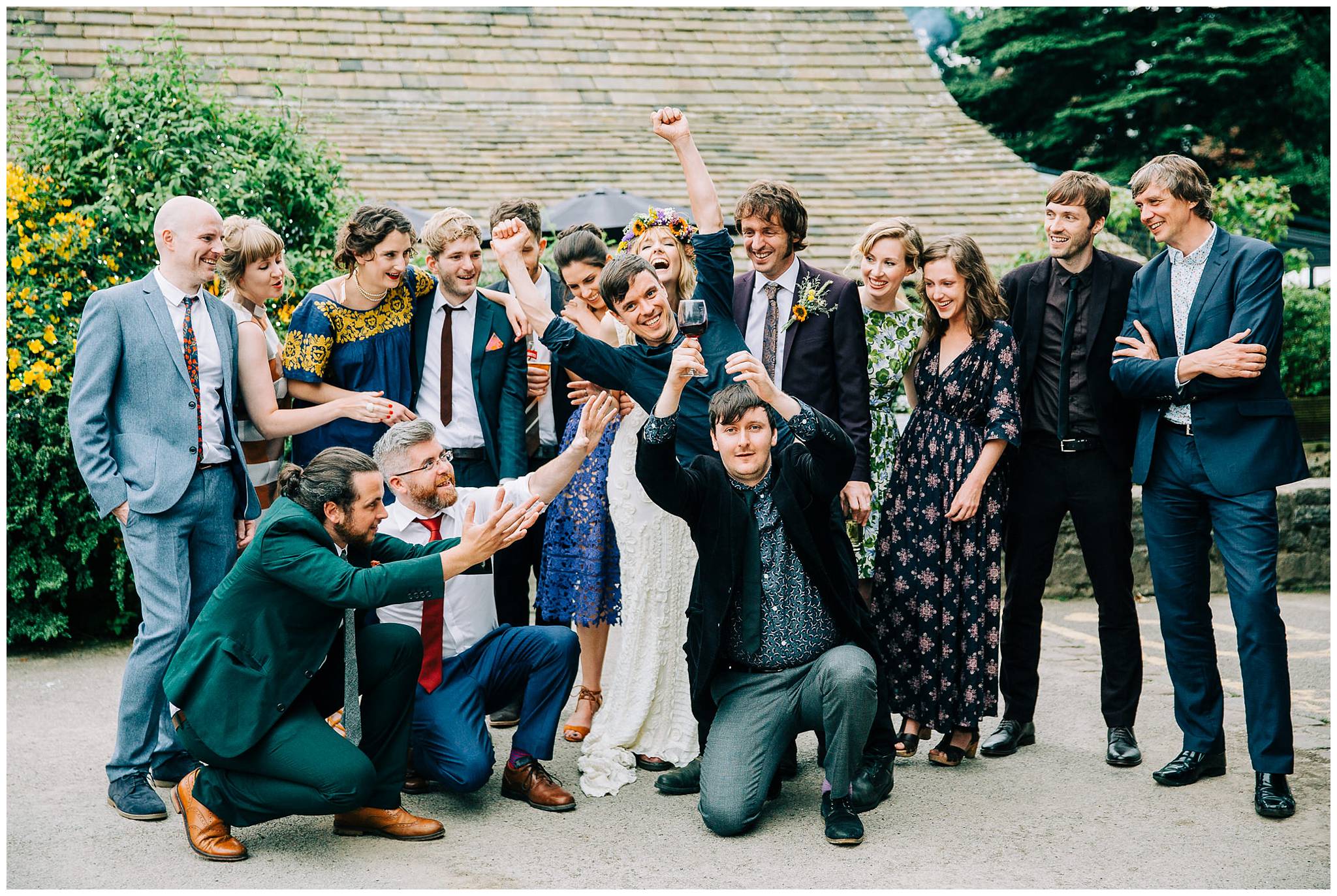 bride and groom with friends being silly for a group photo