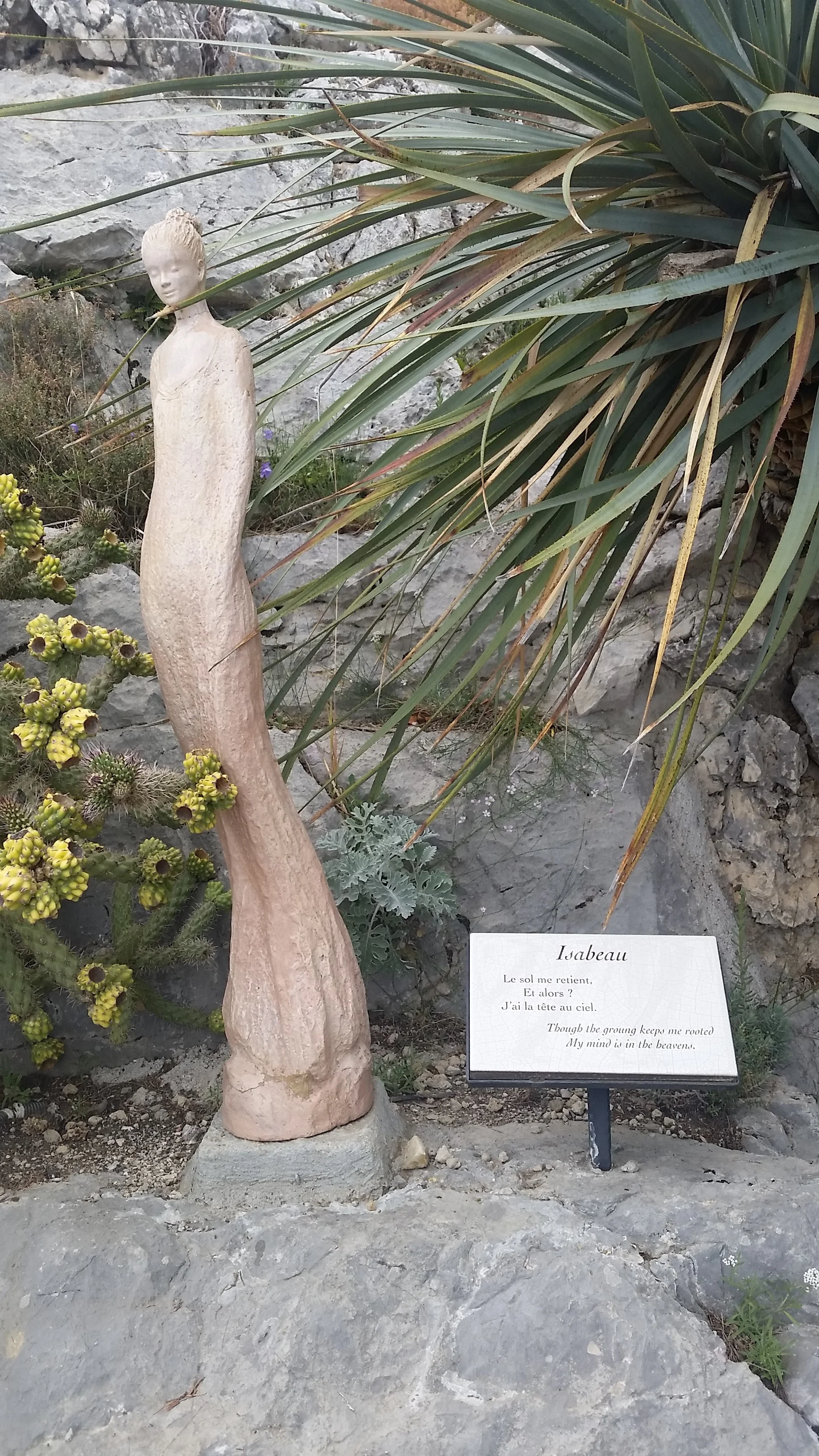 These statues and sculptures were everywhere. This one reads: Though the growing keeps me rooted, my mind is in the heavens.