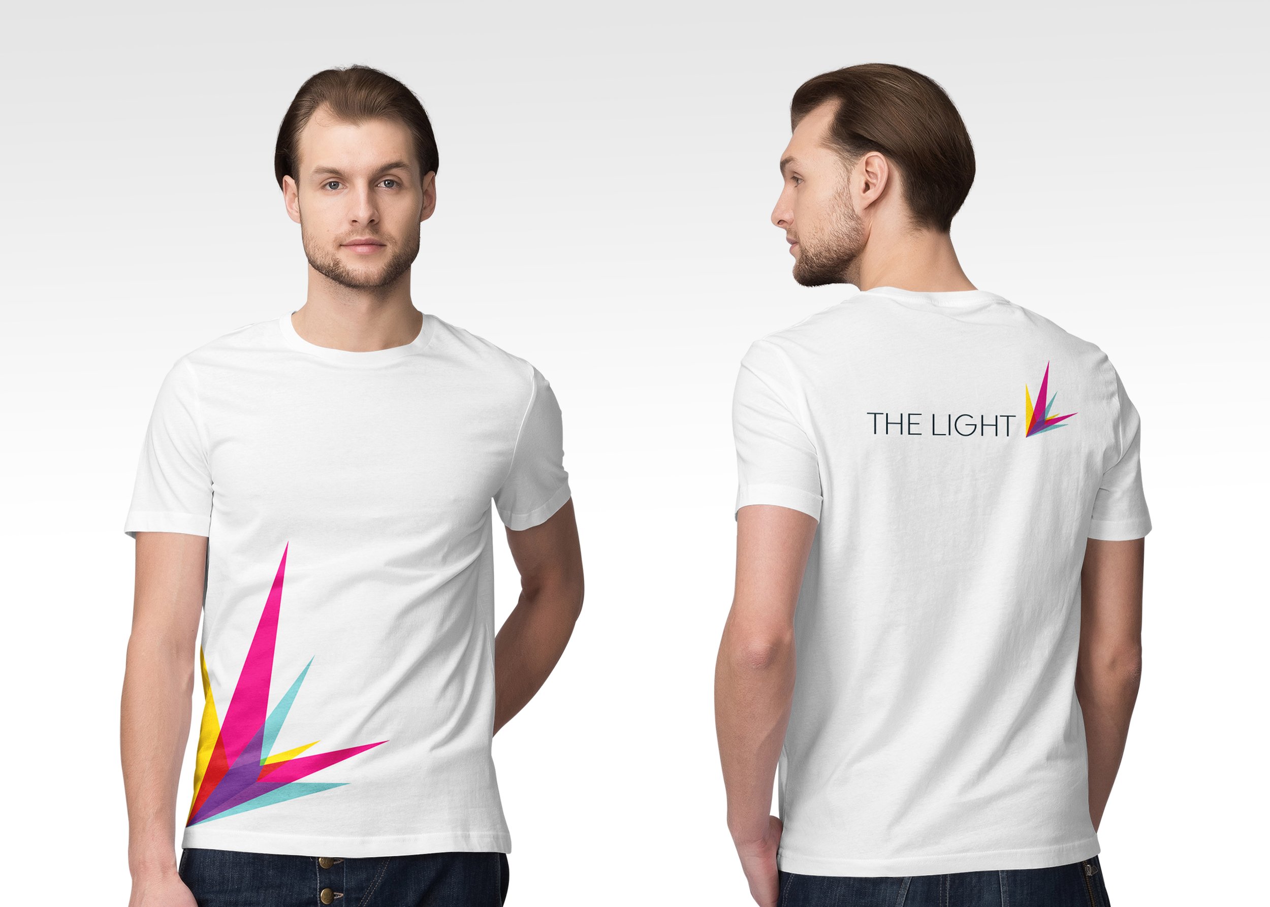 White T-shirt with colourful geometric The Light logo design on front, text 'THE LIGHT' with similar colourful geometric graphic on back, modeled by a young man with brown hair and beard.