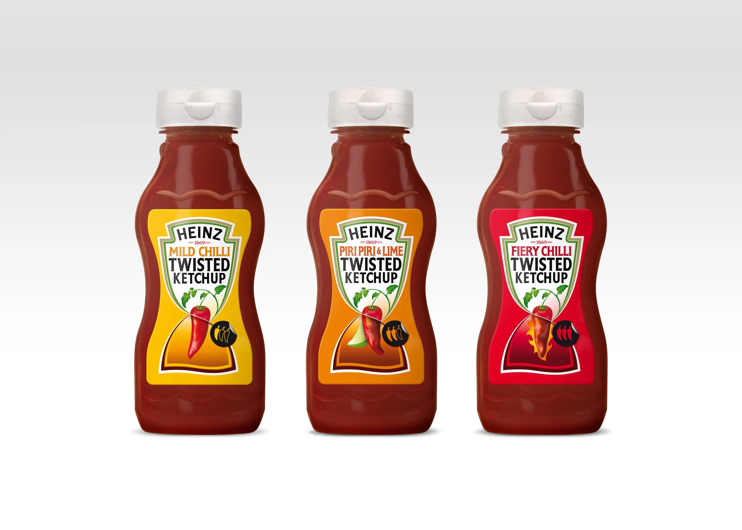 Three bottles of Heinz Twisted Ketchup in different flavors: Mild Chilli, Piri Piri & Lime, and Fiery Chilli, arranged in a row on a white background.